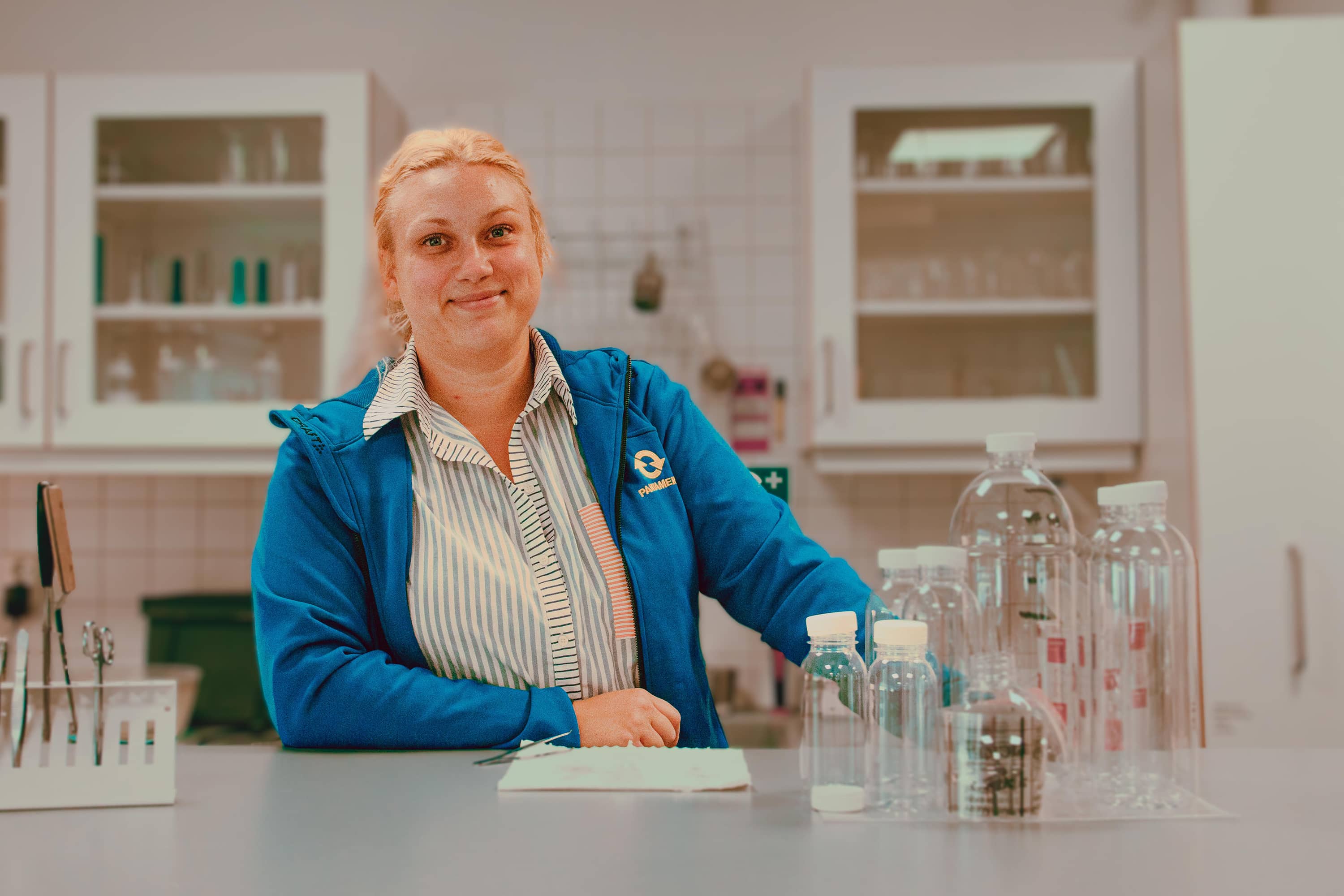 Portrait of woman in a lab posing with lab equipment