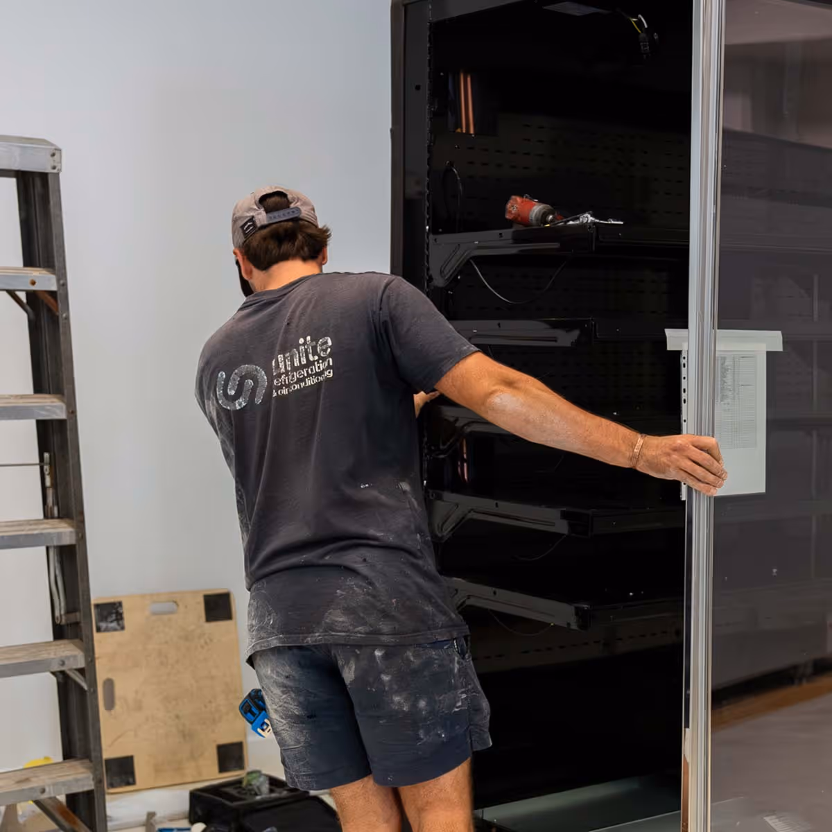 Unite team installing commercial air conditioning system in retail space
