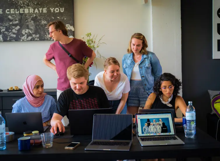 Several colleagues from the Berlin Bytes team working together in the office