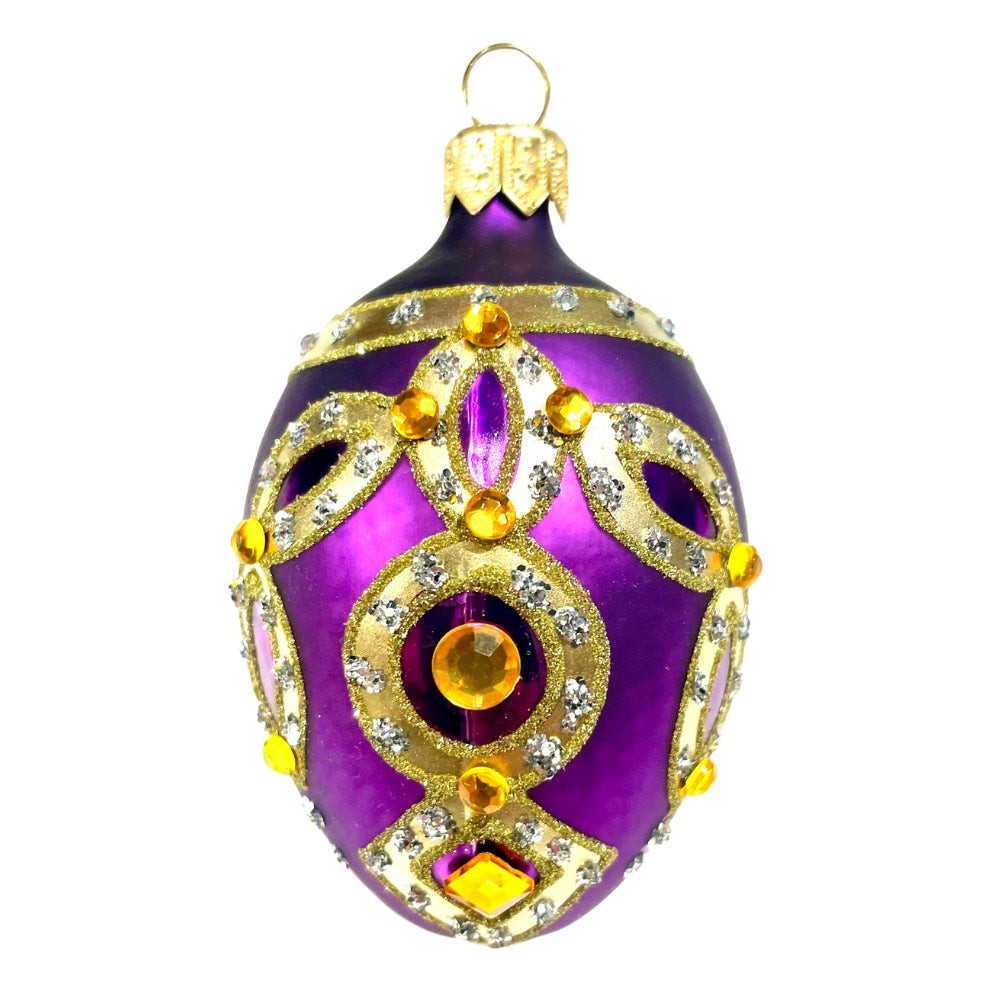 Œuf en verre soufflé violet décoré d'appliques dorées et de strass jaunes