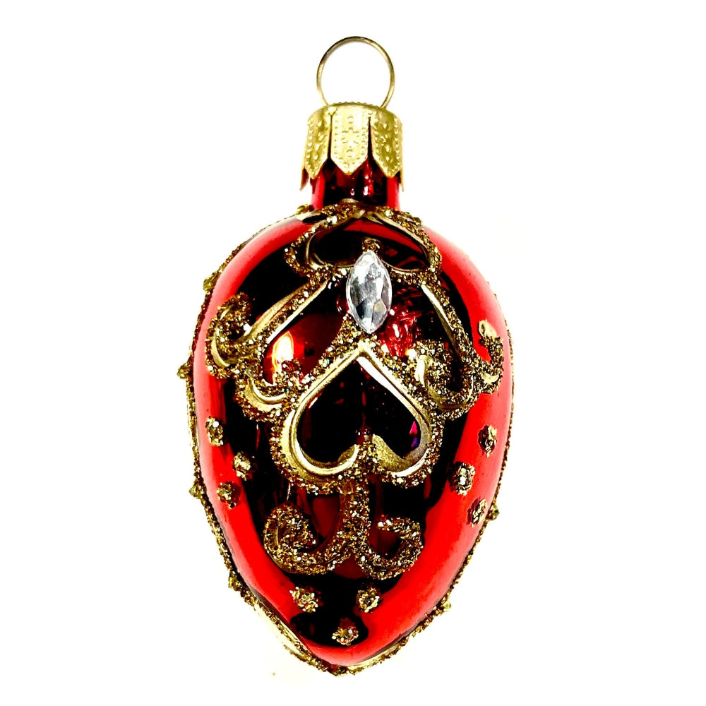 Petit oeuf en verre soufflé rouge et noir décoré d arabesques dorées et d une pampille claire