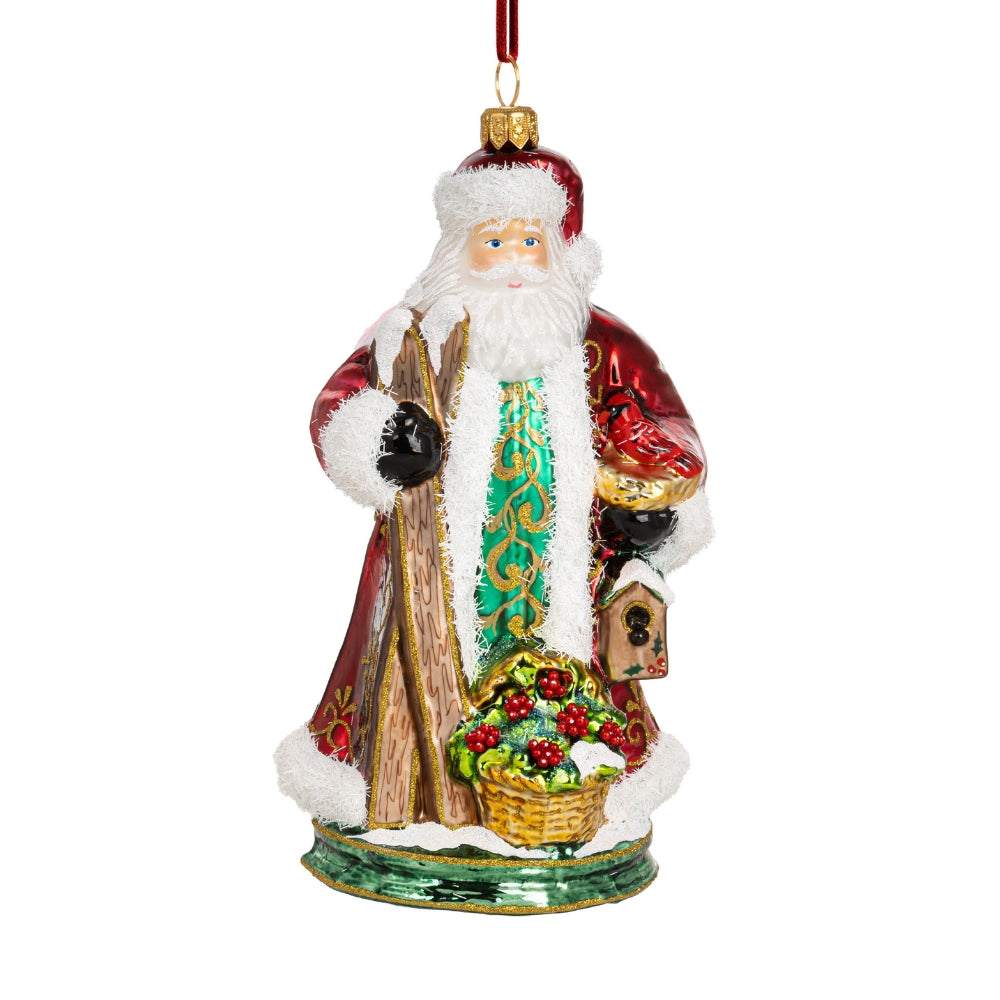 Père Noël en verre soufflé rouge et vert tenant des skis, décoré de blanc