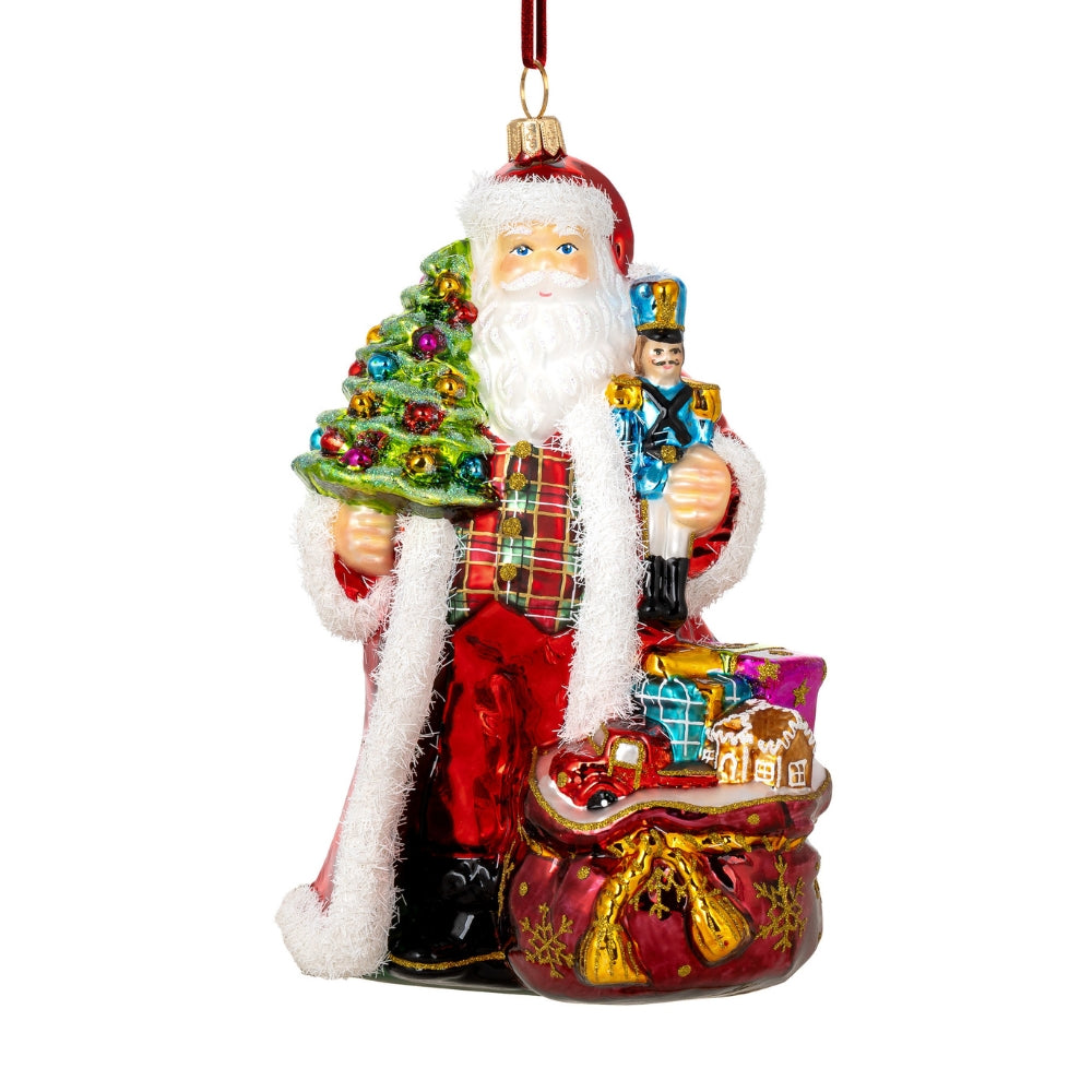 Père Noël en verre soufflé tenant un sapin et un casse-noisette, sac de cadeaux rouge