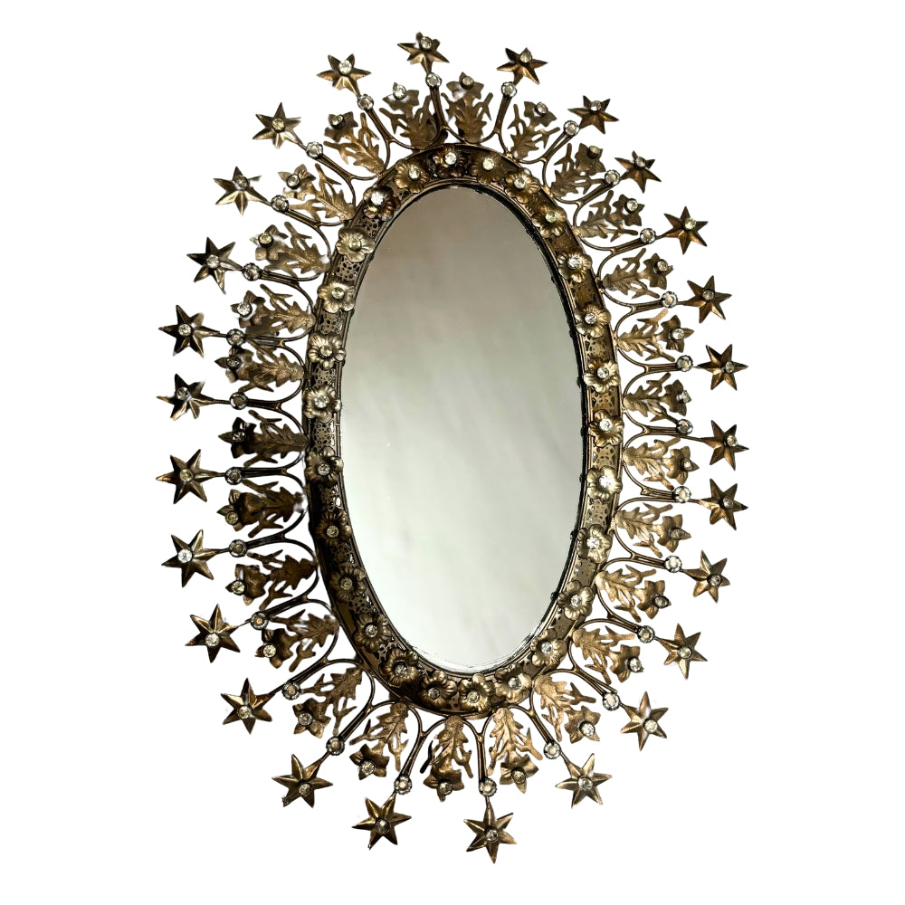 Miroir ovale ex-voto en métal doré, encadré de fleurs et d'étoiles rayonnantes