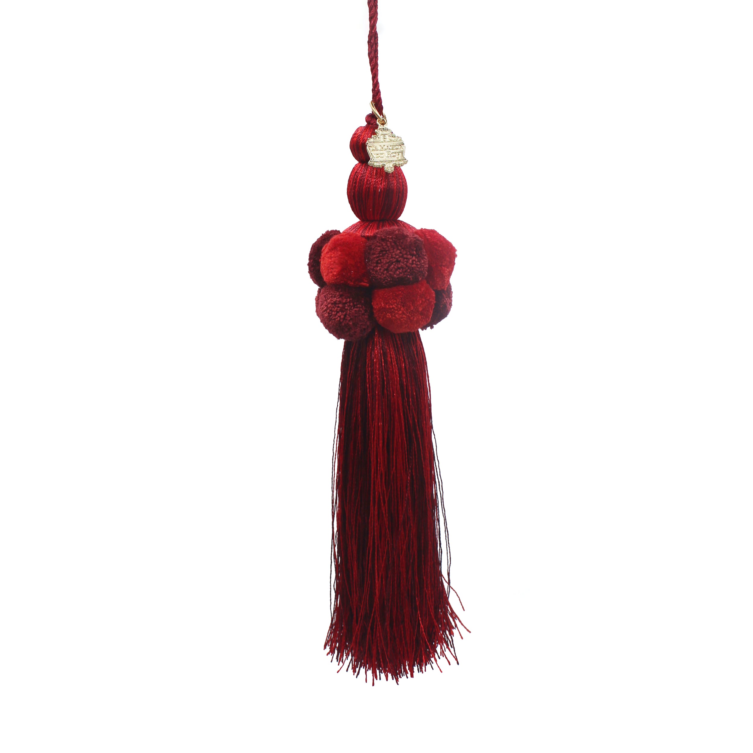 Pompon en coton rouge et bordeaux à longs fils avec écusson doré