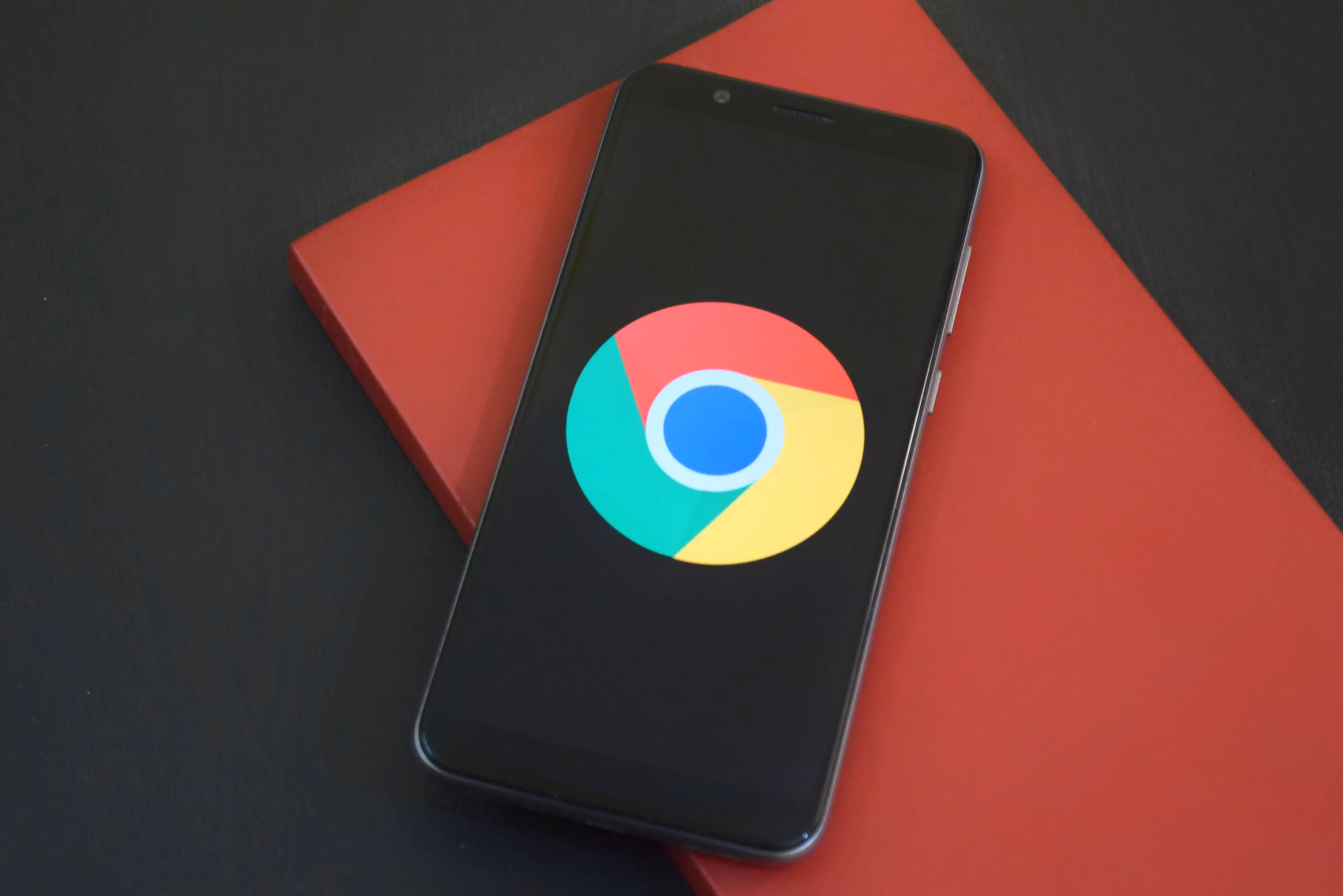 A close up of a cell phone with the google logo on it