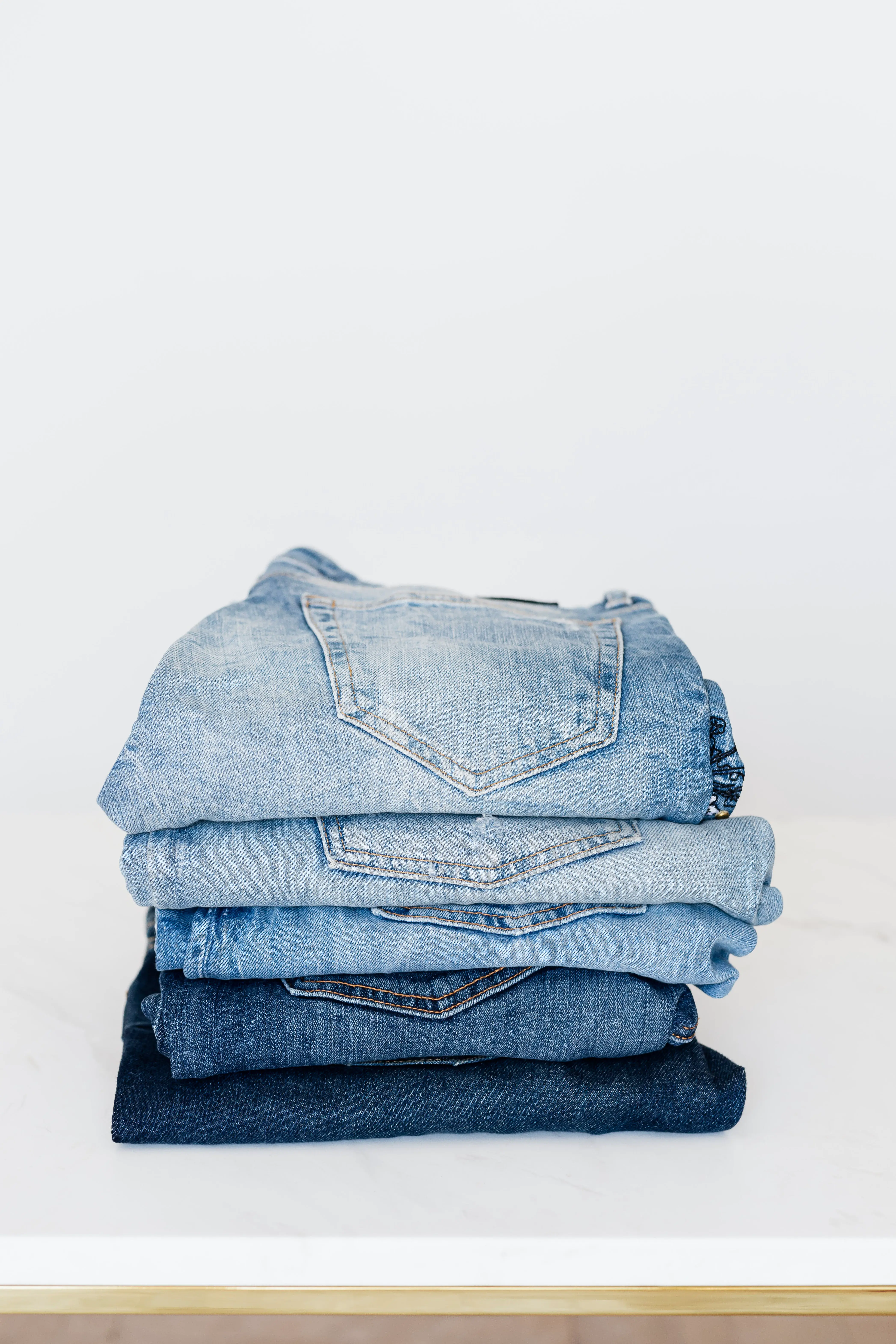 A stack of jeans sitting on top of a table