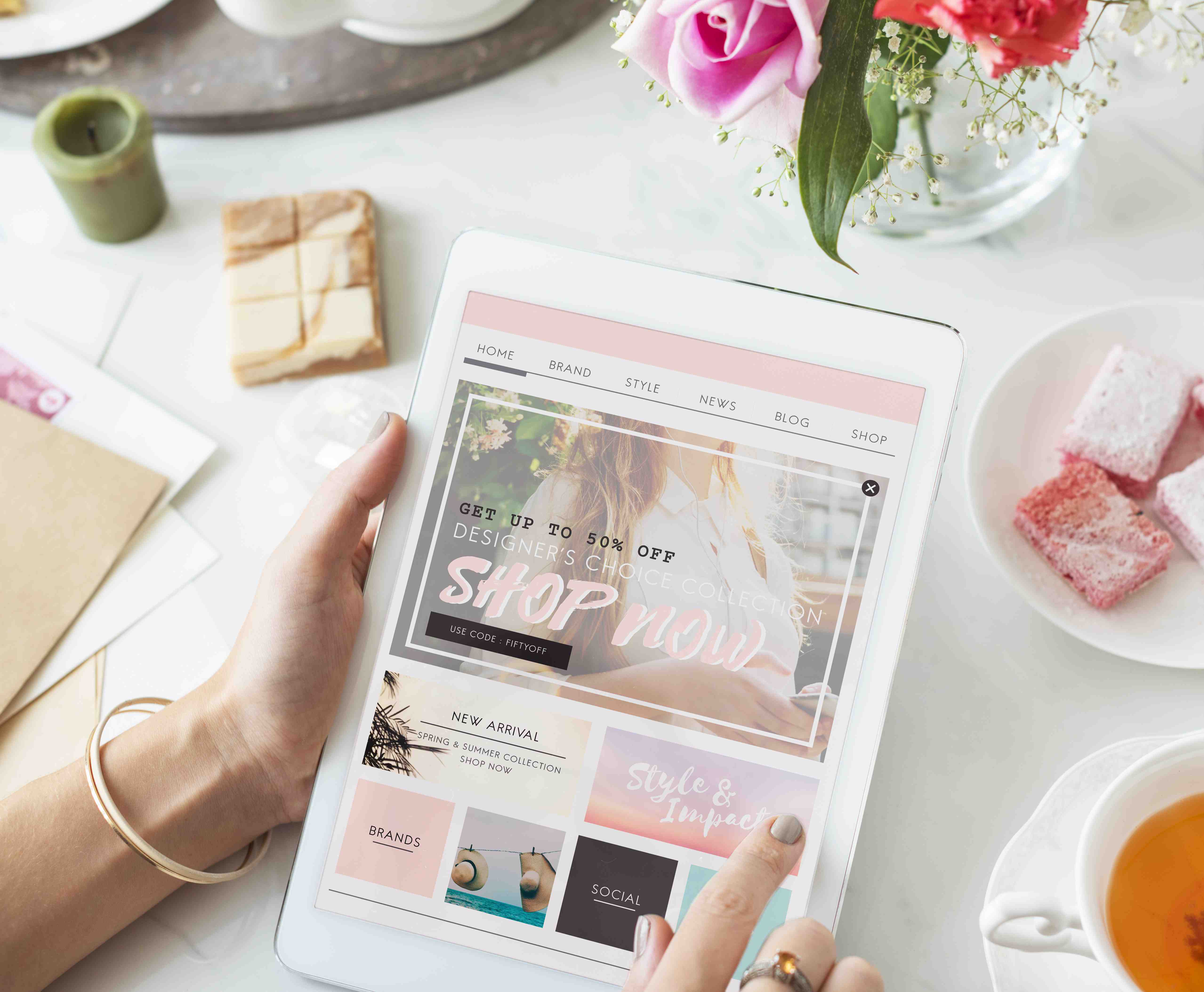 A person holding a tablet with a website on it