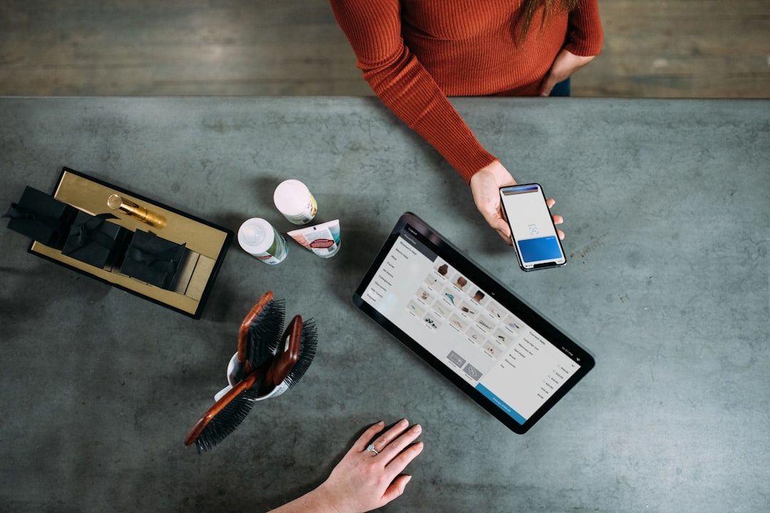 A person sitting at a table with a tablet