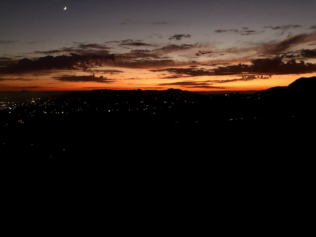 A view of a city at night from a hill