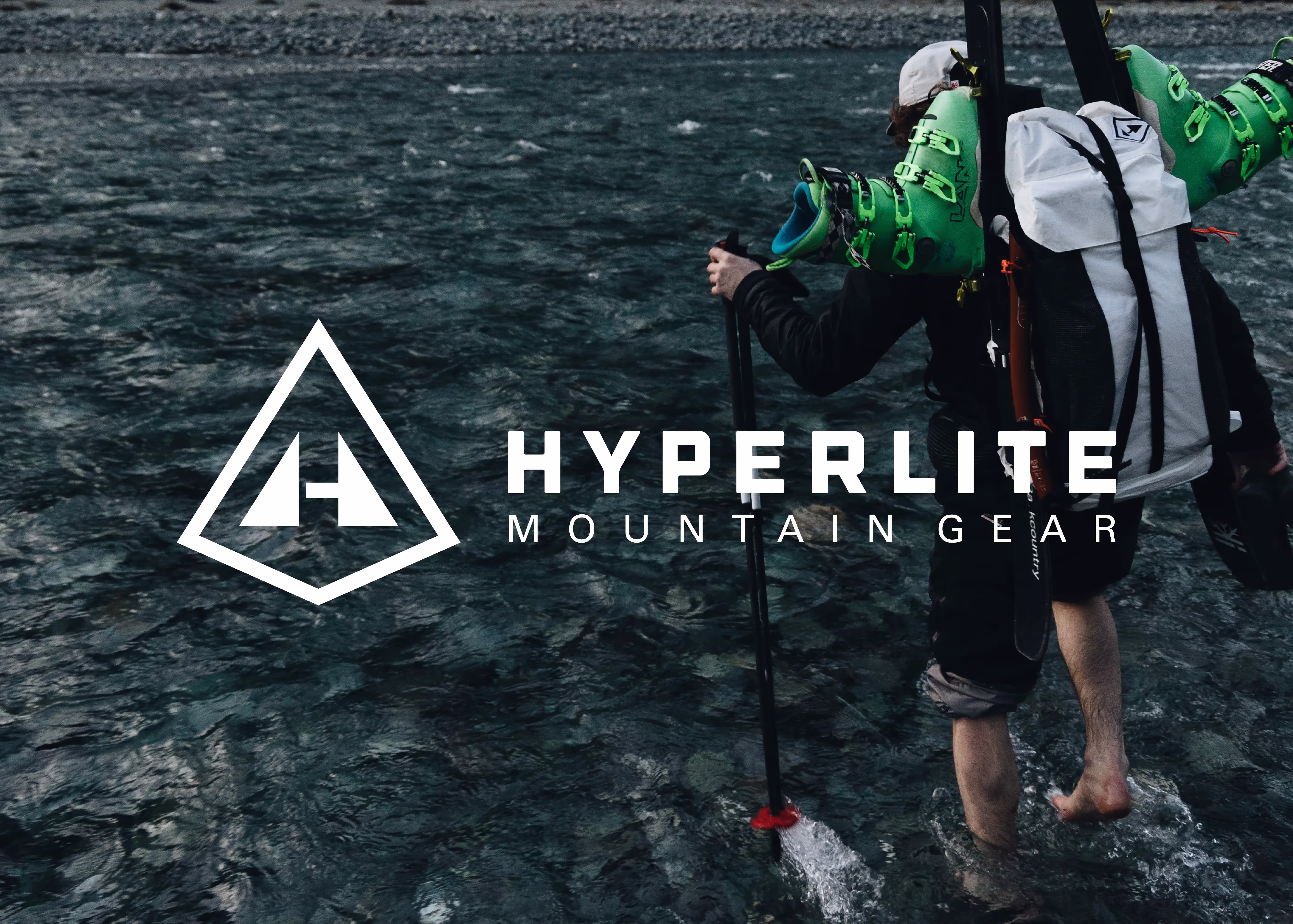 A man standing in the water holding a fishing pole