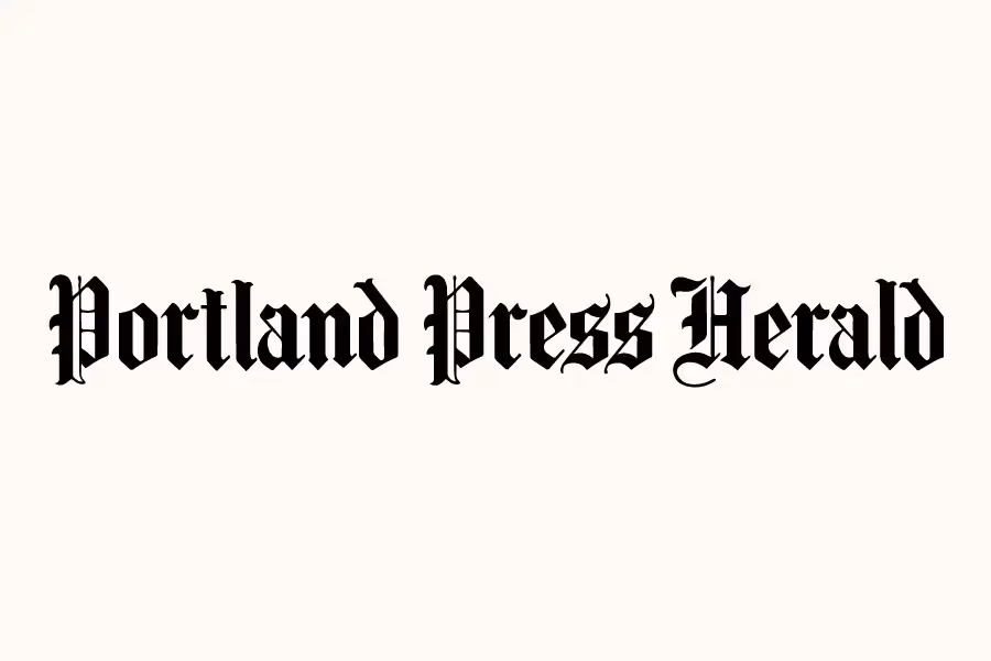 Portland Press Herald newspaper logo in black ornate gothic text on beige background