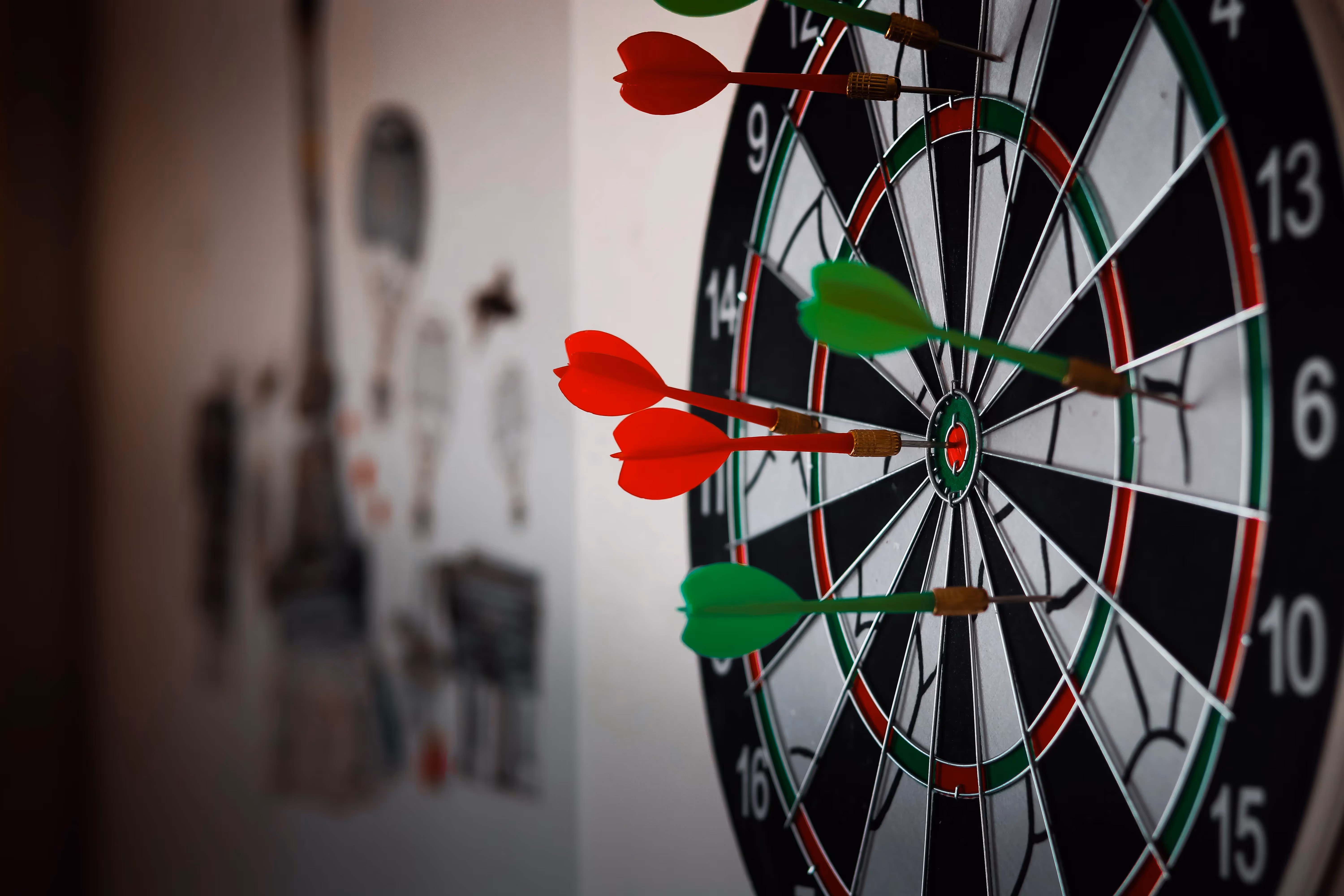 A dart hitting in the center of a dartboard