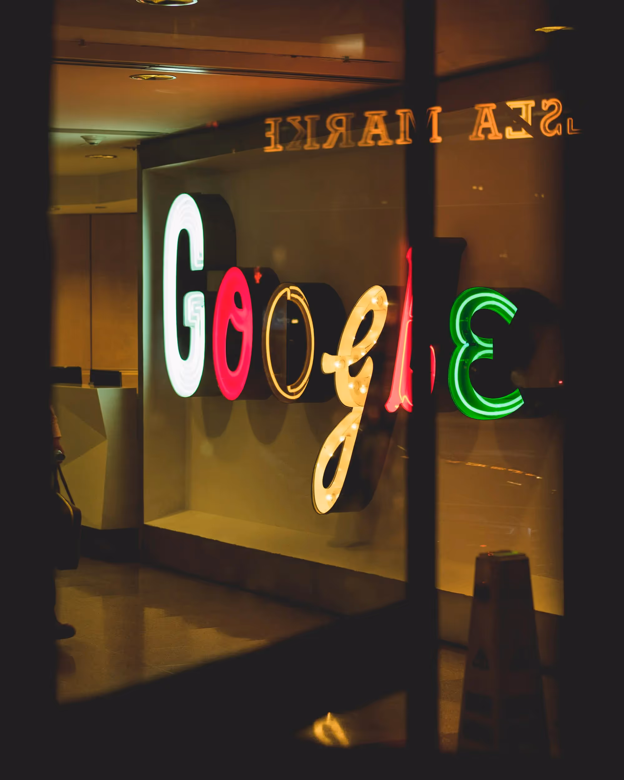 A store front window with a neon sign in the window