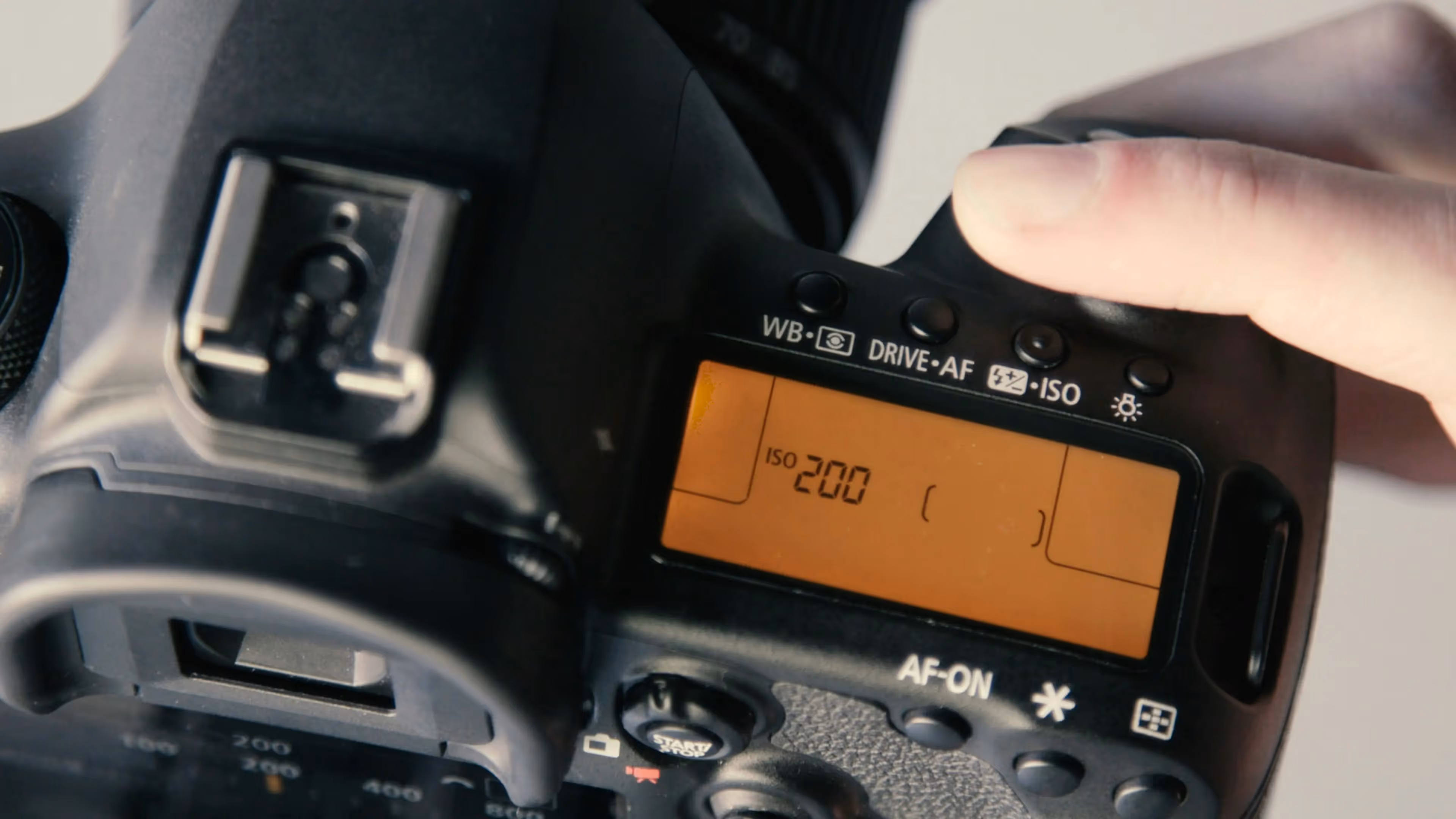 A person holding a camera with a digital screen