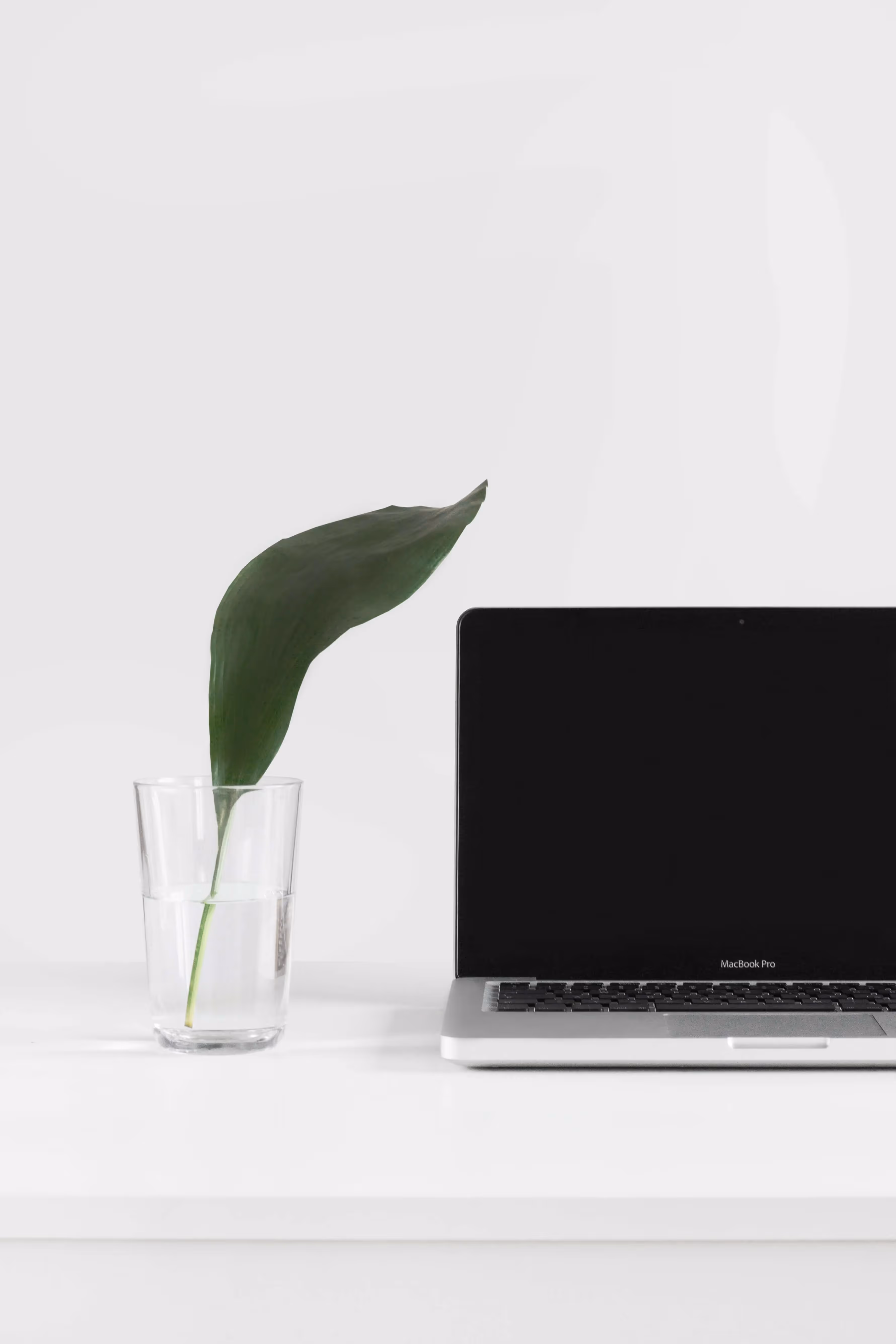 A laptop computer sitting on top of a white desk