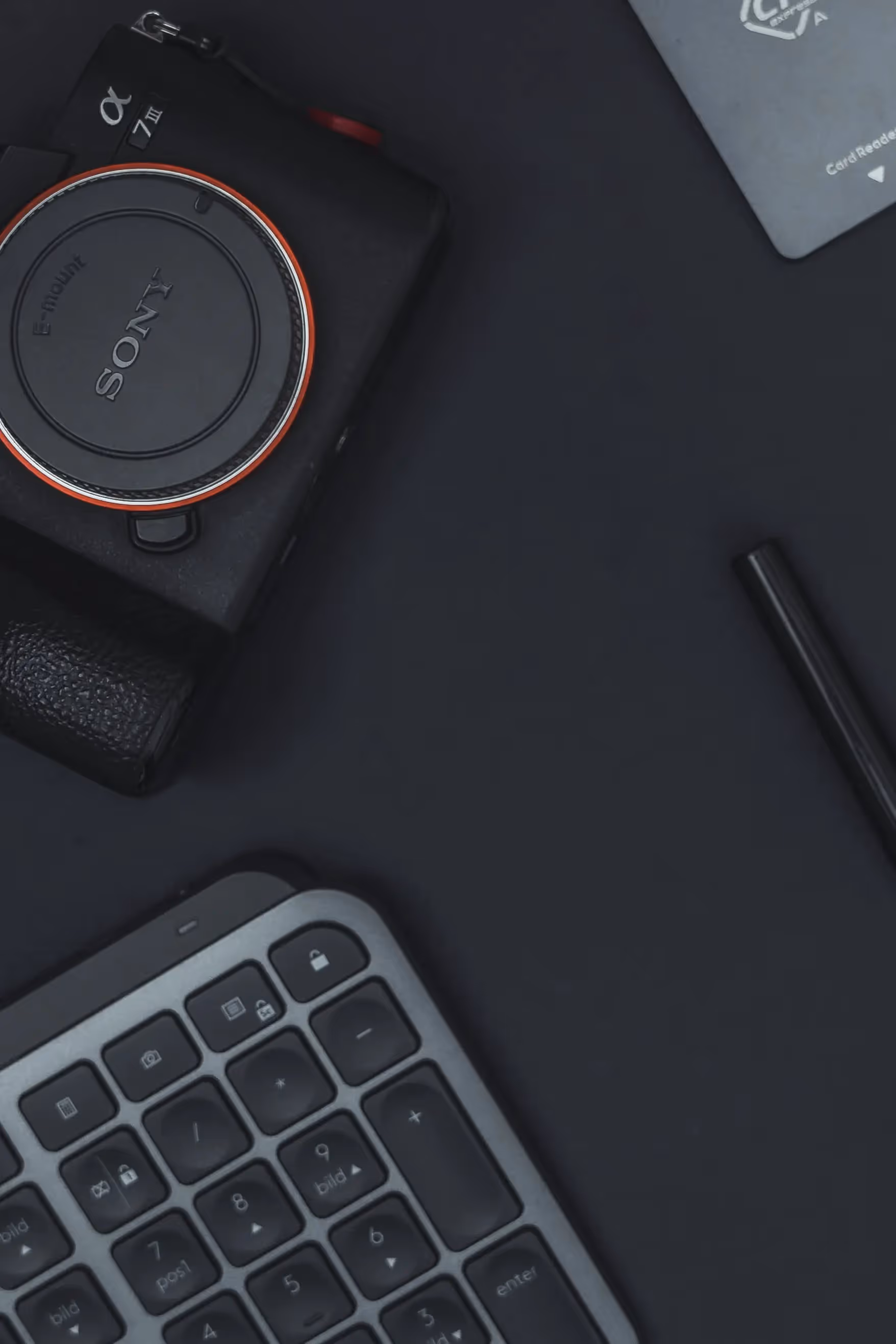 A camera and a keyboard on a table