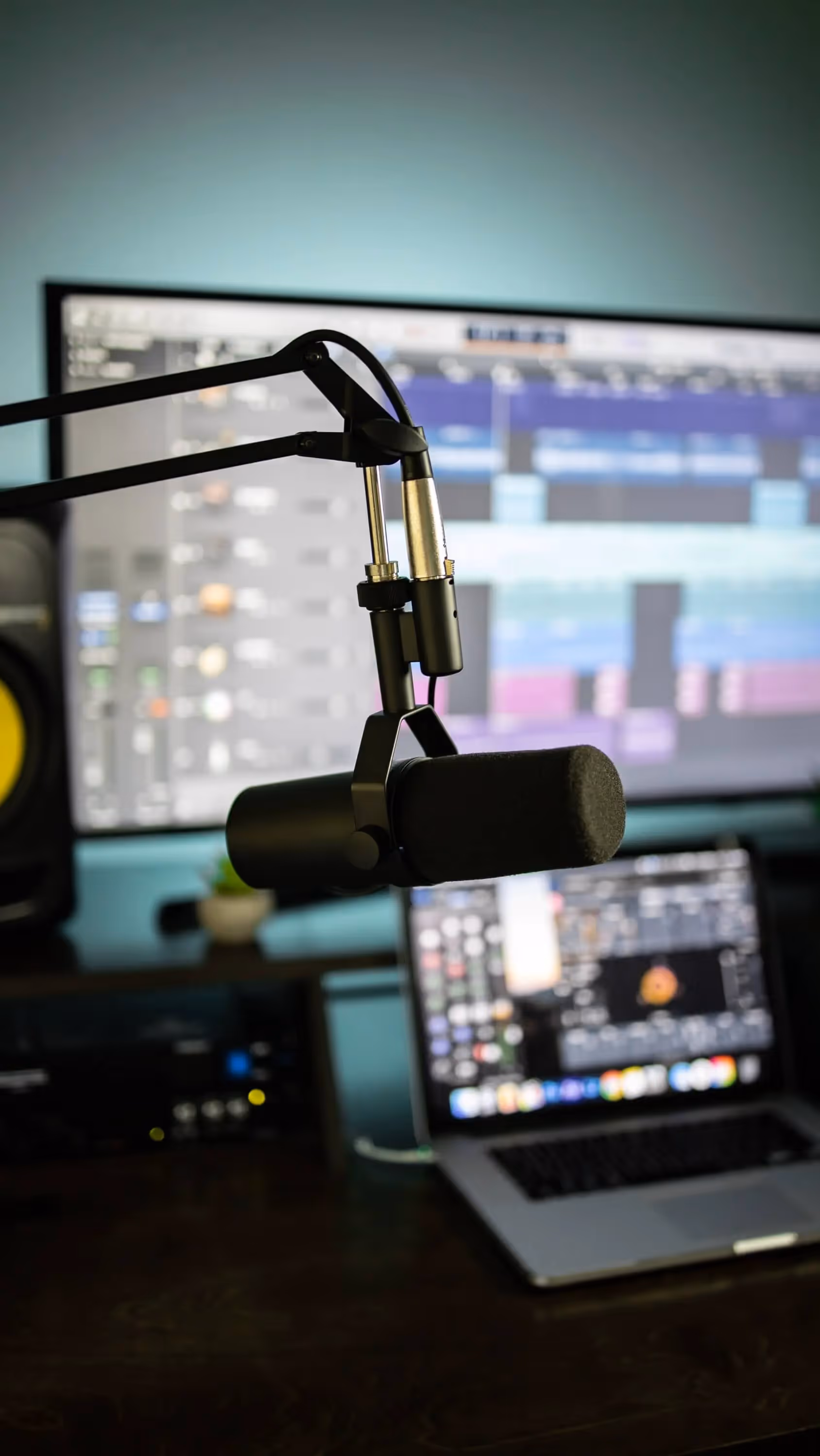 A laptop computer sitting next to a microphone