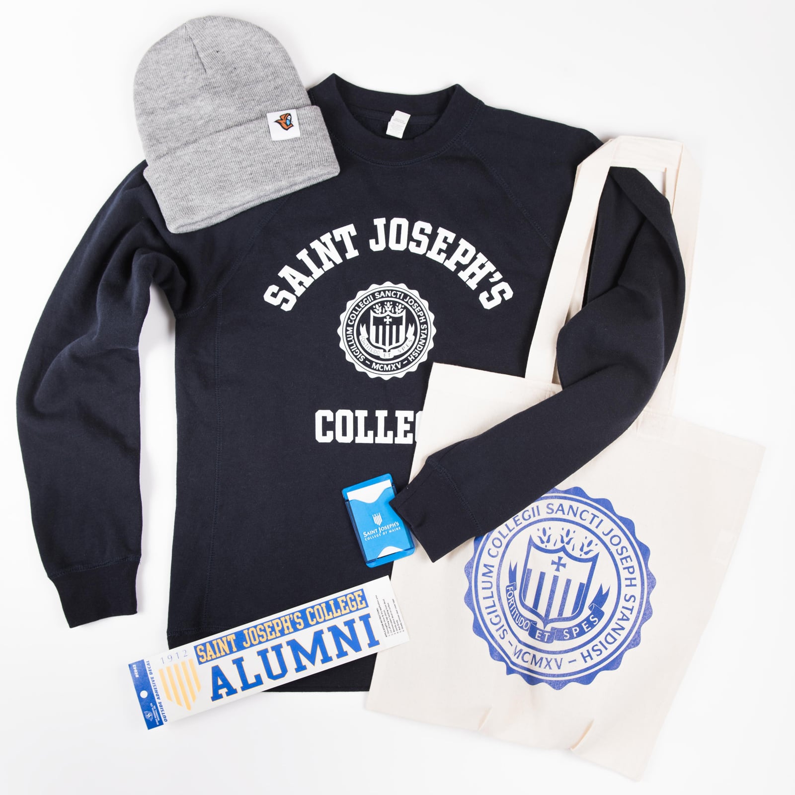 Saint Joseph's College sweatshirt, beanie, tote bag and alumni decal arranged on white