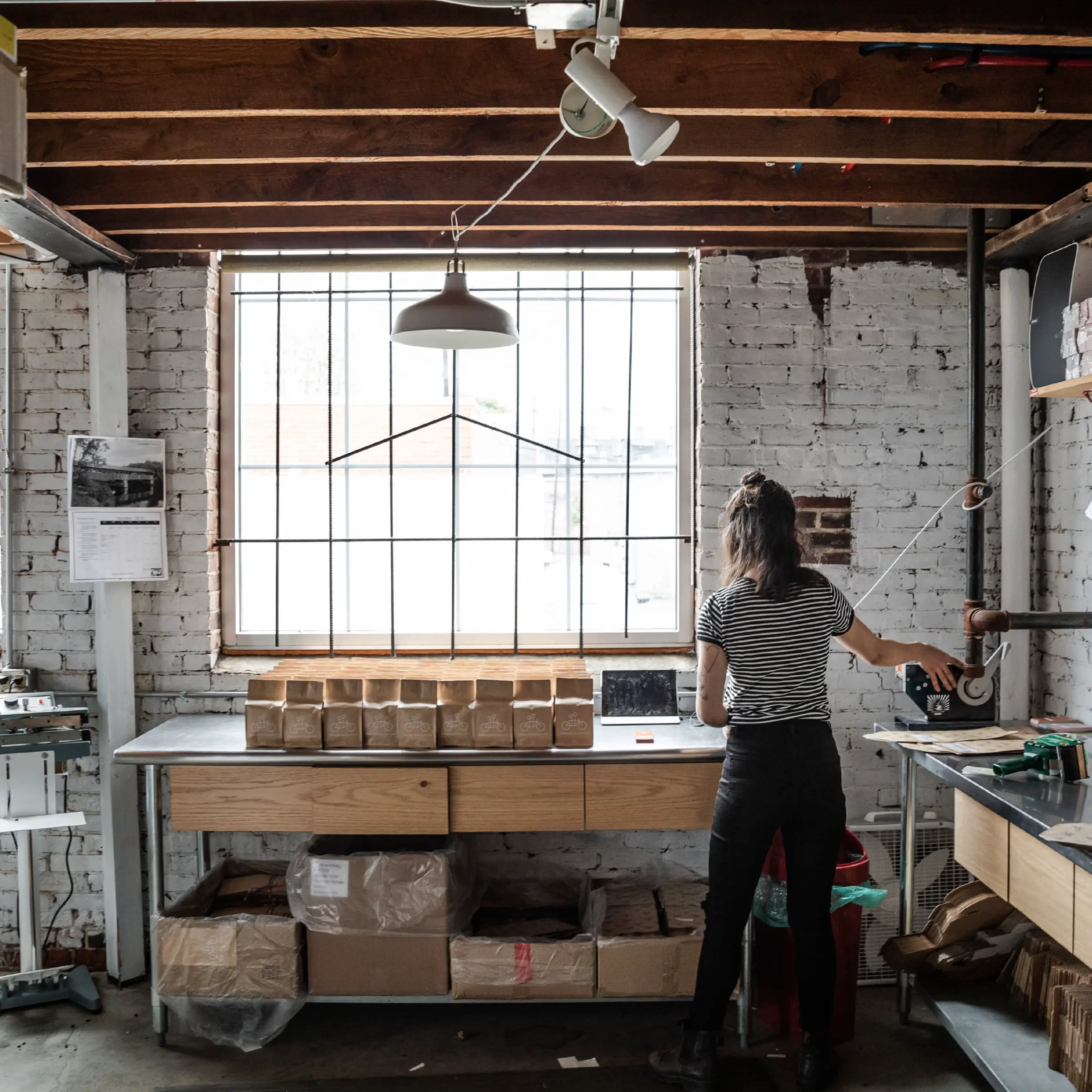 Tandem Coffee team member packing orders in the roastery