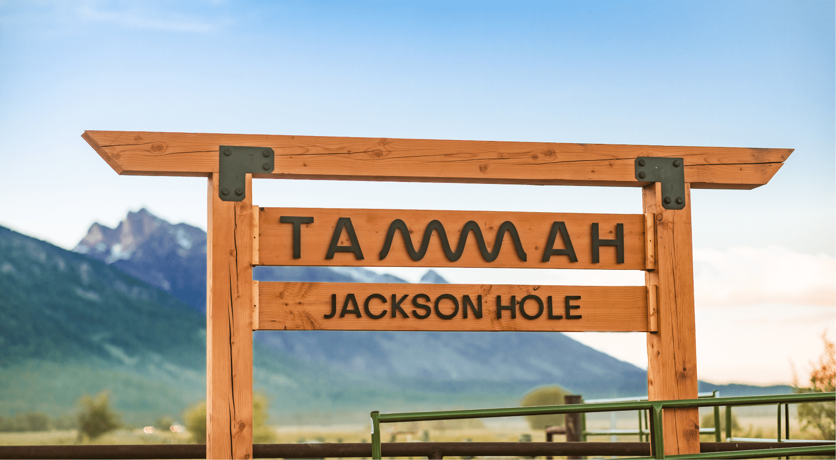 Tammah Jackson Hole sign in front of Grand Teton Mountain range.