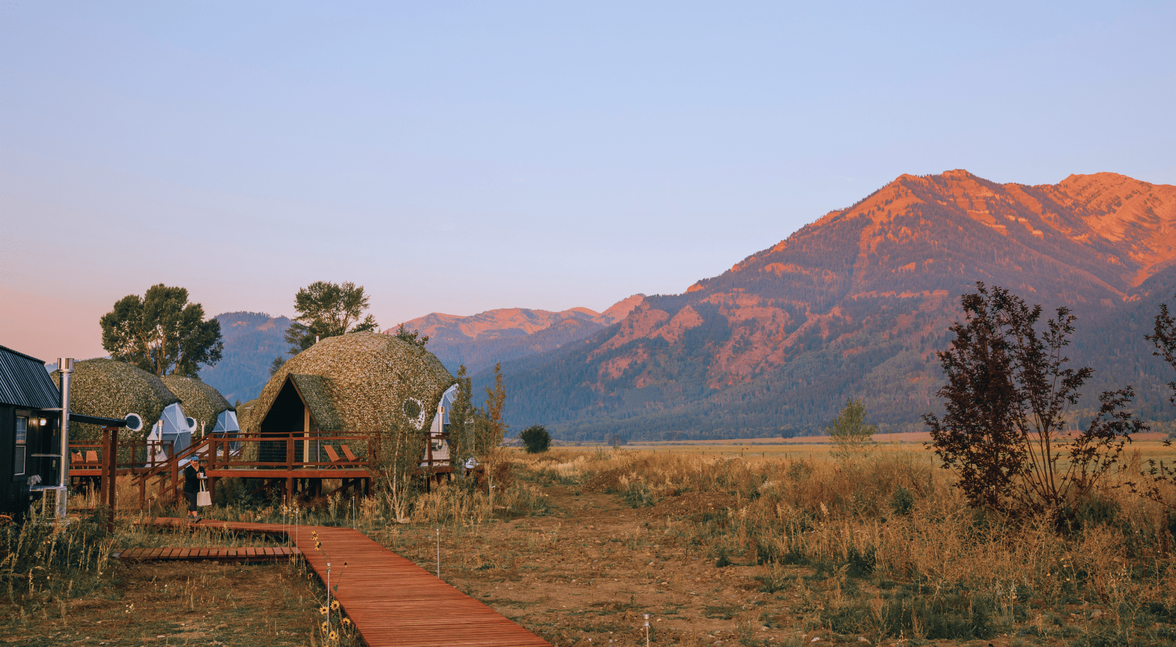 Geodesic dome in front of Teton Mountains.