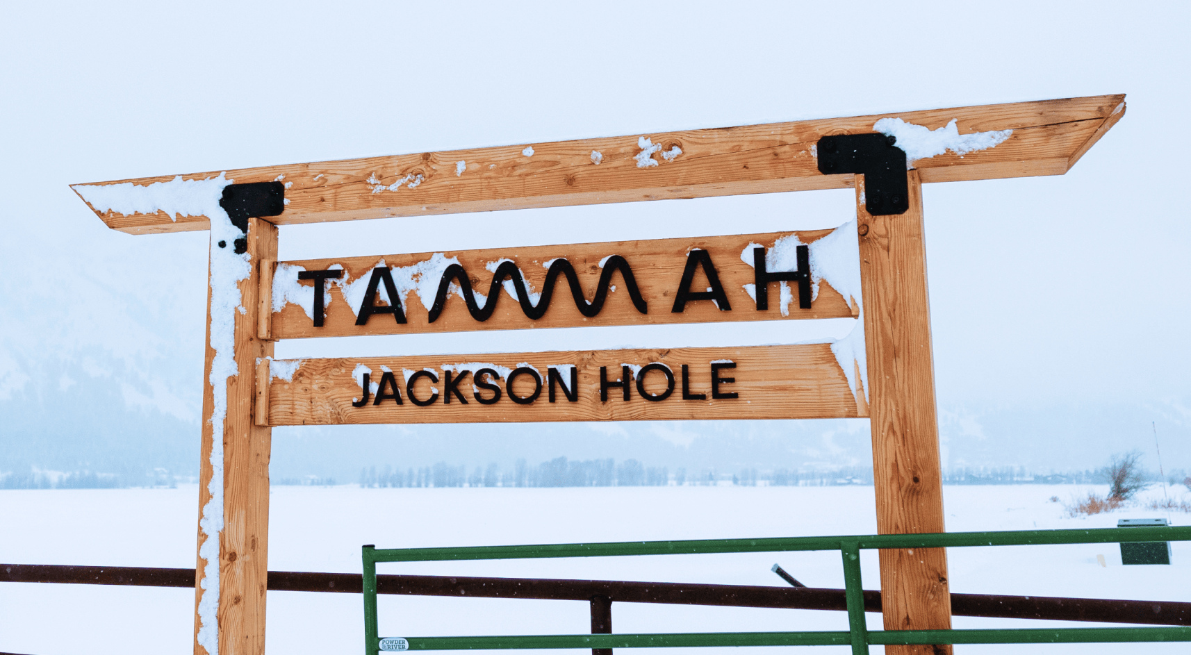 Tammah Jackson Hole sign in front of Grand Teton Mountain range.