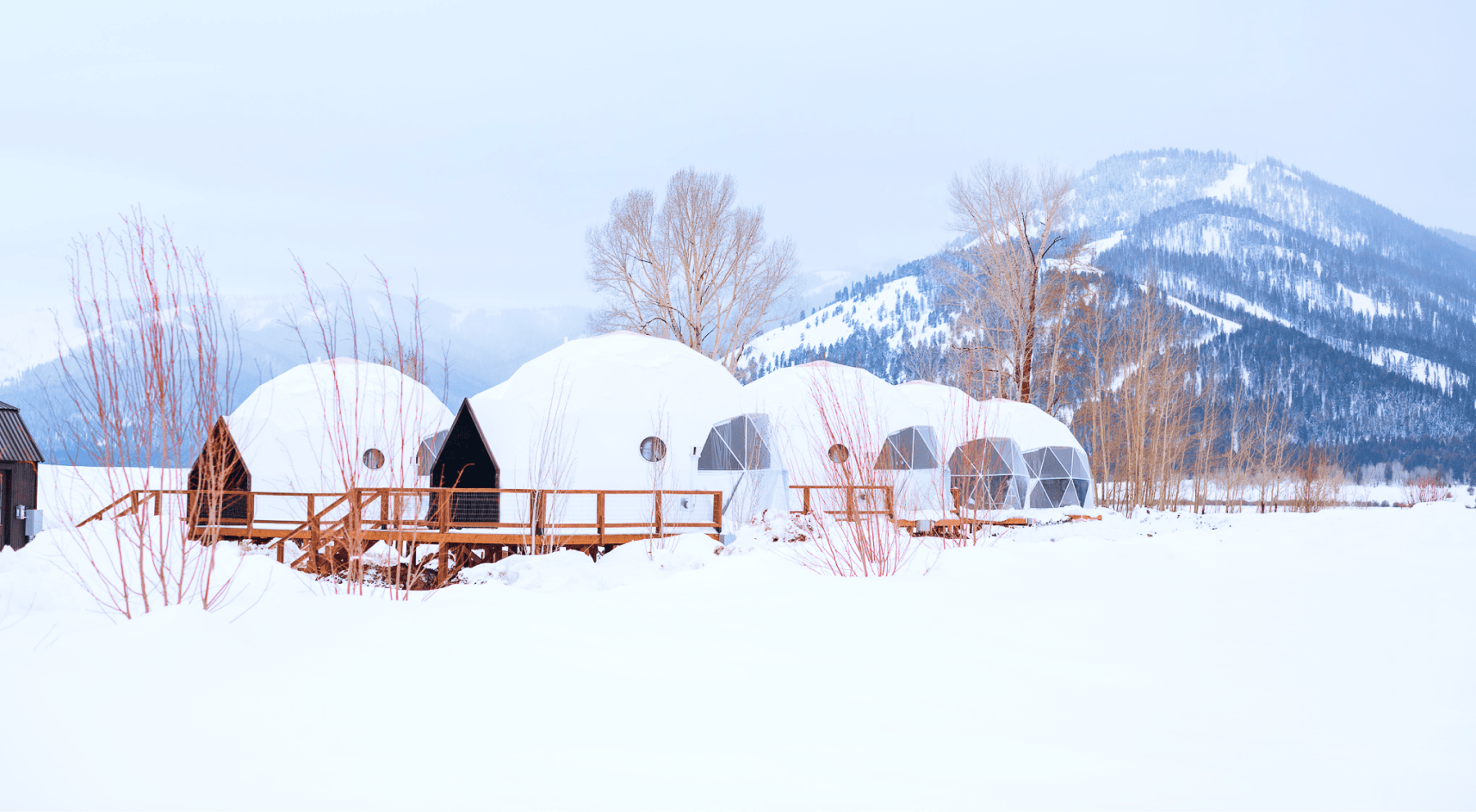 Geodesic domes in front of Grand Teton Mountains in the winter.