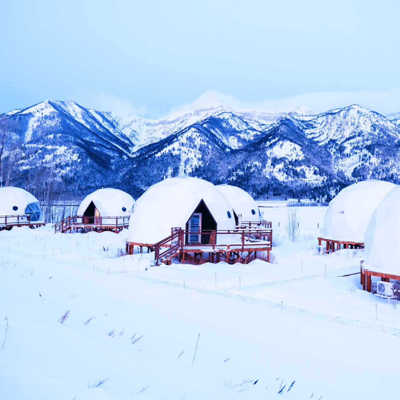 Geodesic dome in front of Teton Mountains.