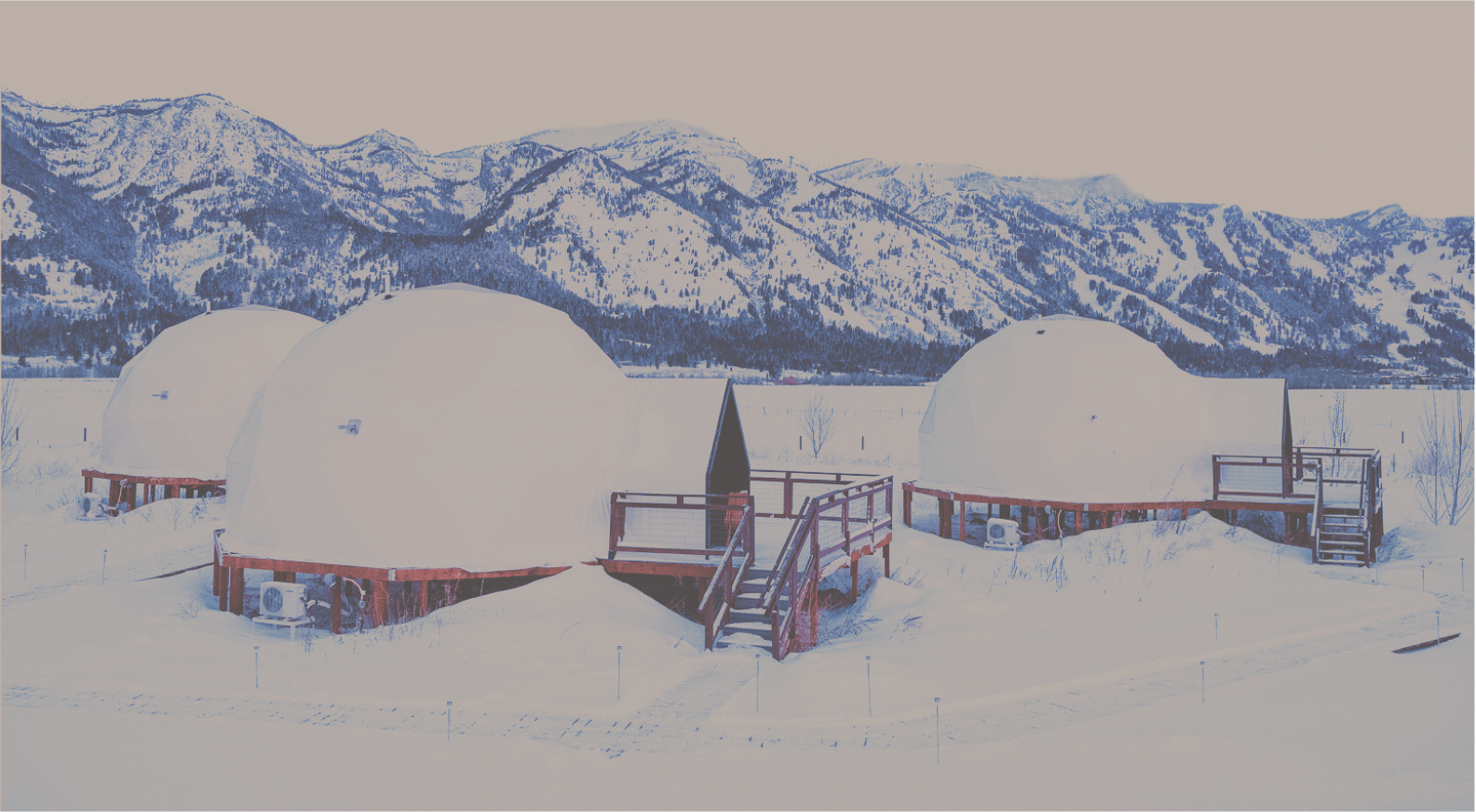Geodesic domes in front of Tetons with sky cut out