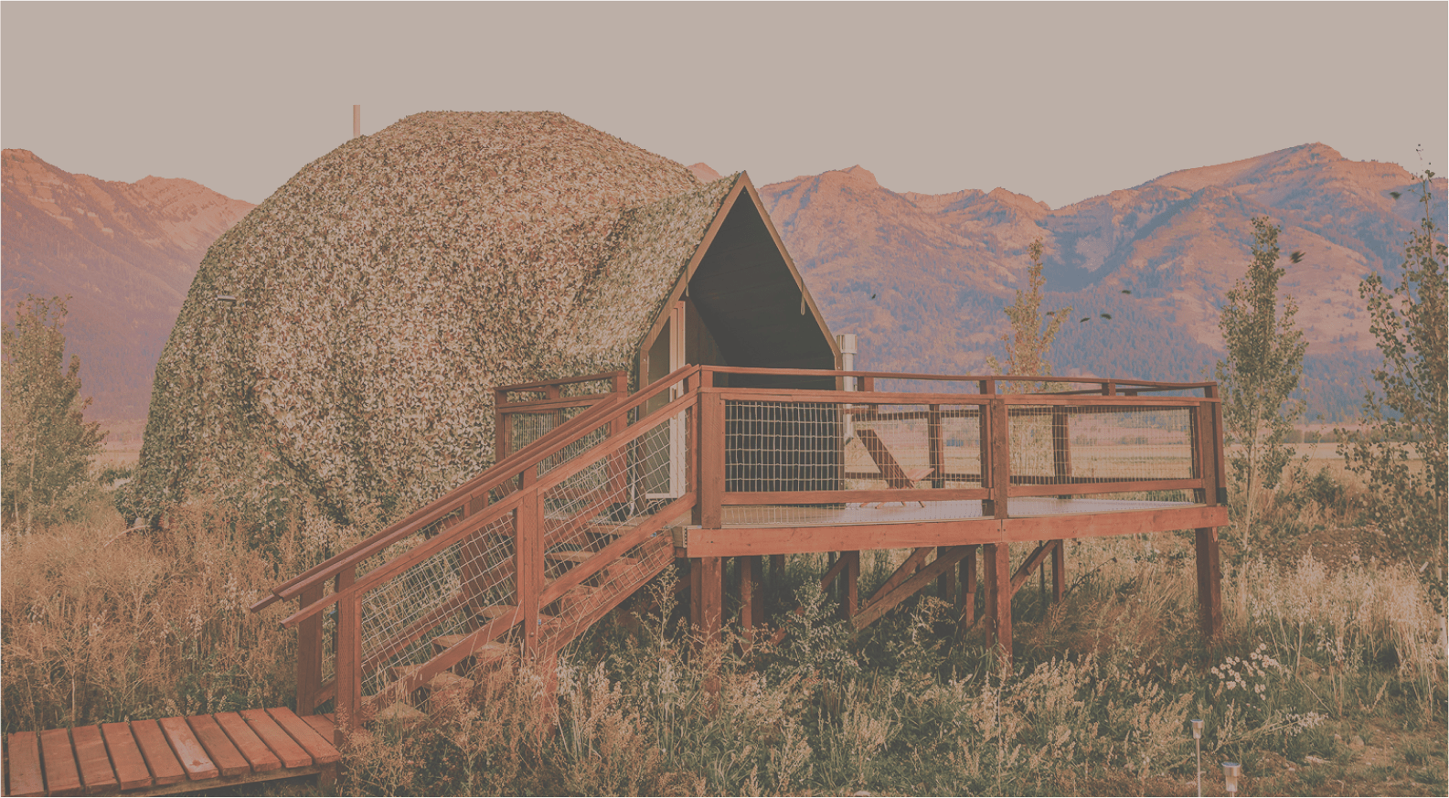 Geodesic domes in front of Tetons with sky cut out