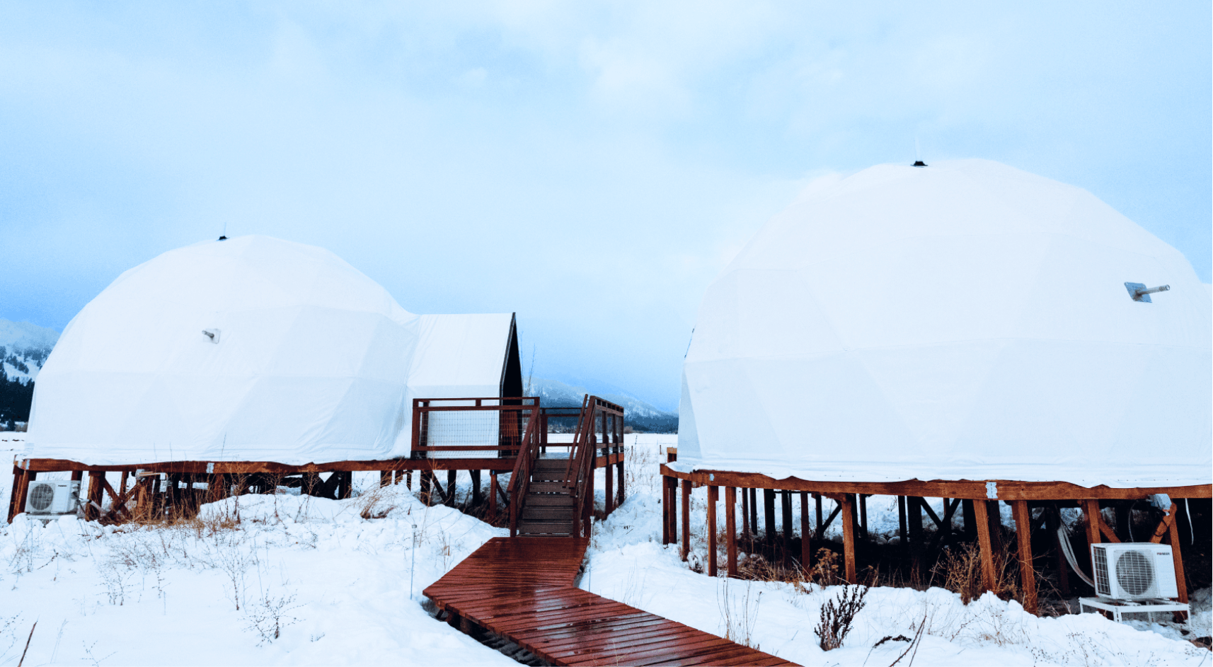 Geodesic domes in front of Grand Teton Mountains in the winter.
