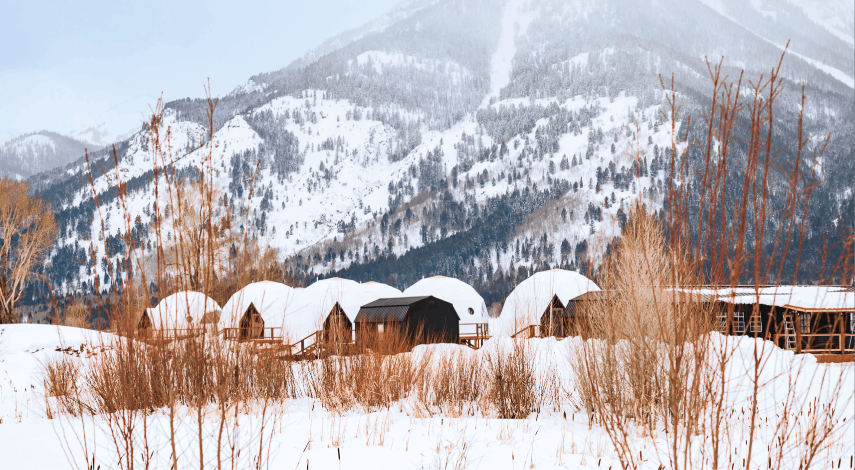 Geodesic domes in front of Grand Teton Mountains in the winter.
