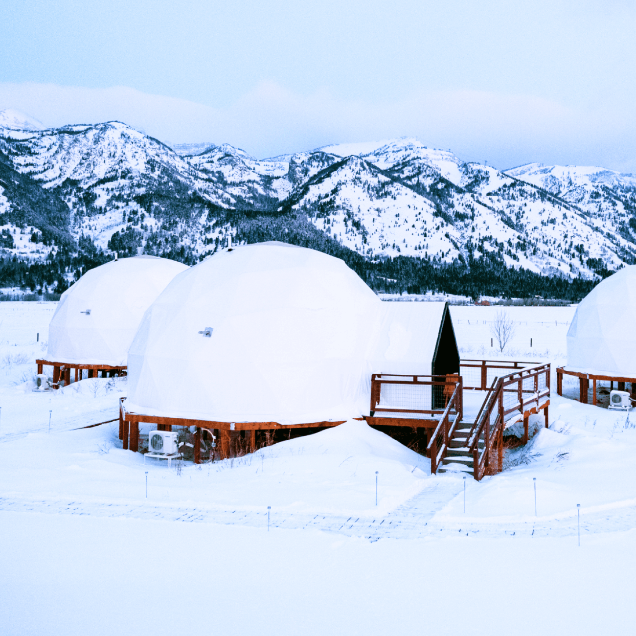 Geodesic dome in front of Teton Mountains.