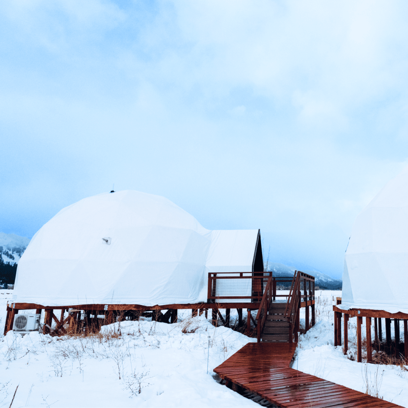 Geodesic domes in front of Grand Teton Mountains in the winter.