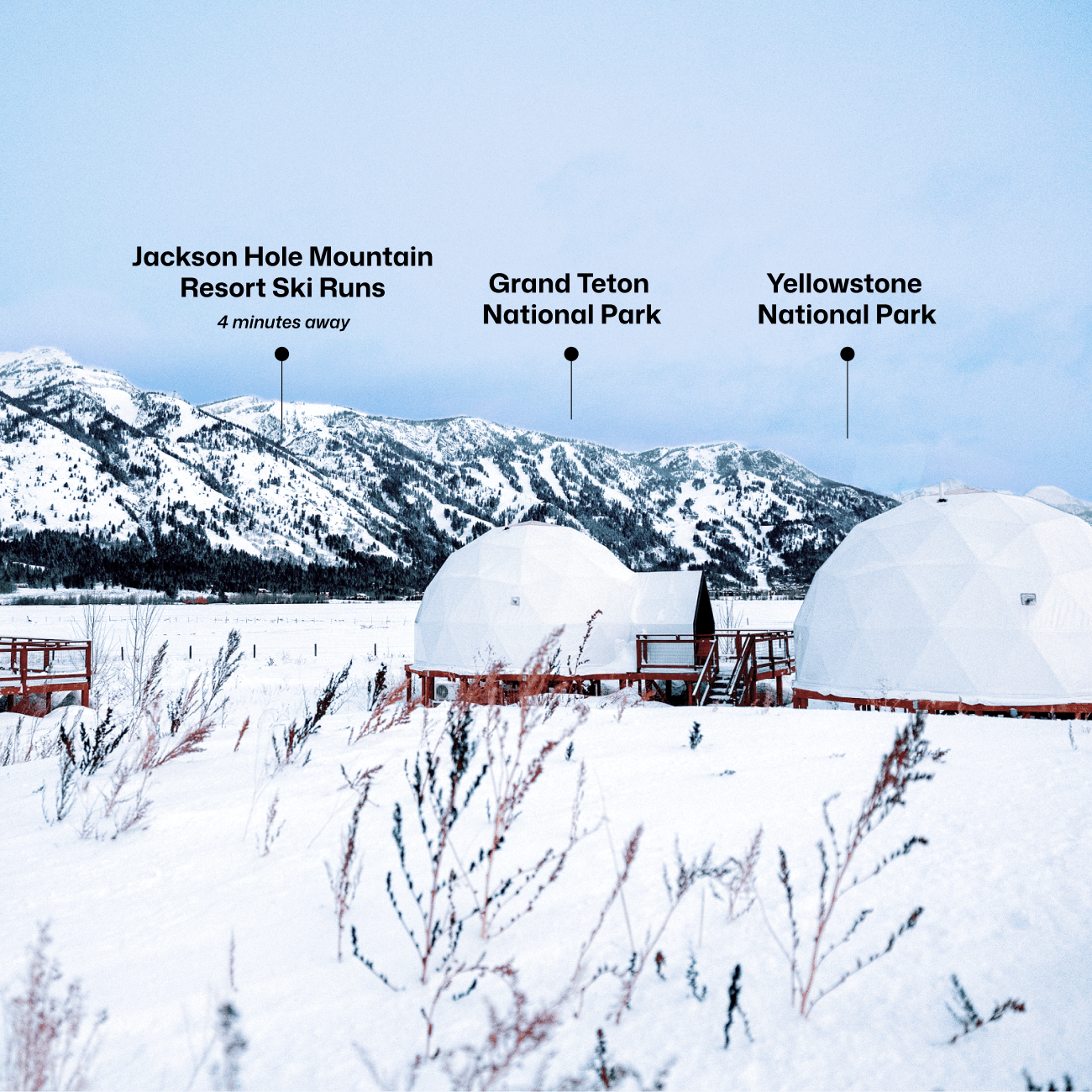 Geodesic dome in front of stream and Teton Mountains with pins pointing out JHMR, Grand Teton National Park, and Yellow Stone National Park.