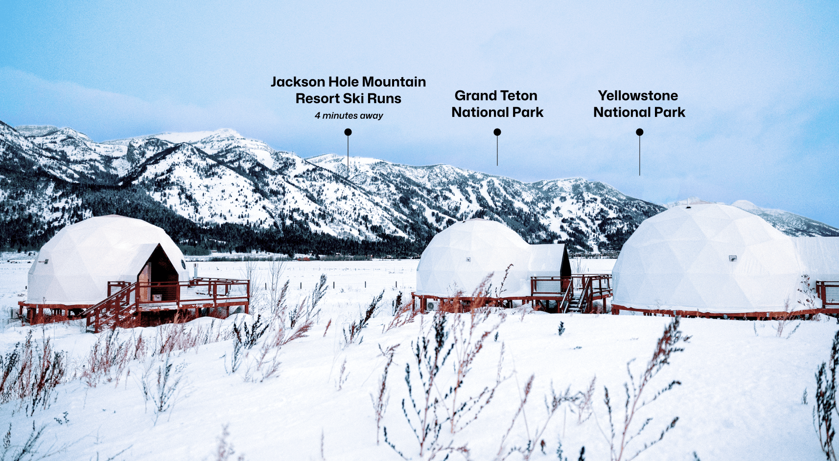 Geodesic dome in front of stream and Teton Mountains with pins pointing out JHMR, Grand Teton National Park, and Yellow Stone National Park.