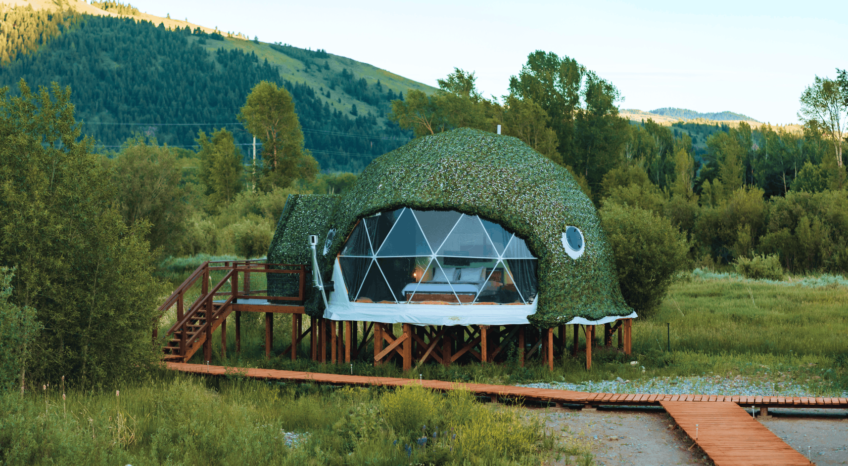 Tammah Jackson Hole sign in front of Grand Teton Mountain range.