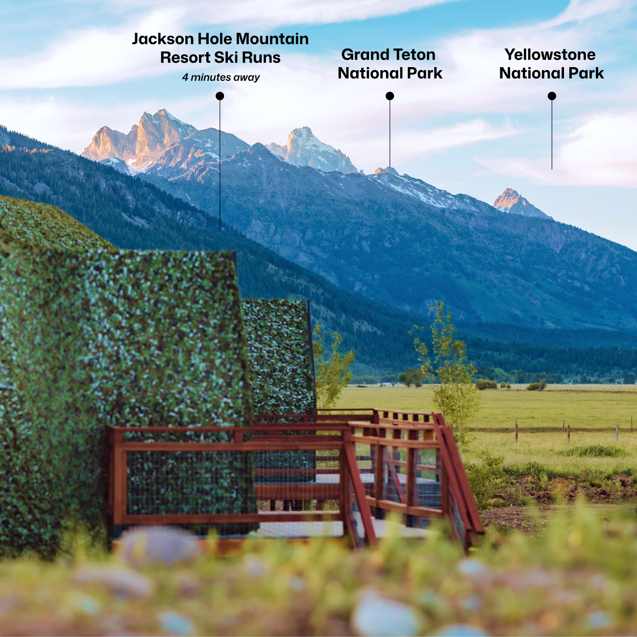 Geodesic dome in front of stream and Teton Mountains with pins pointing out JHMR, Grand Teton National Park, and Yellow Stone National Park.
