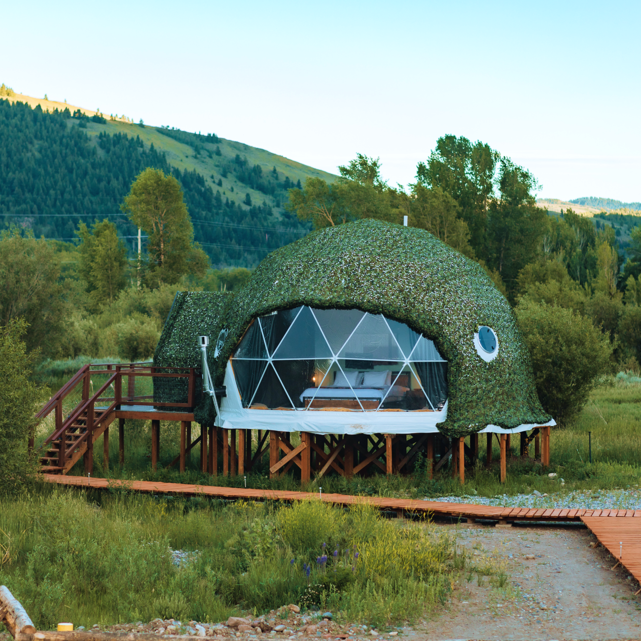 Tammah Jackson Hole sign in front of Grand Teton Mountain range.
