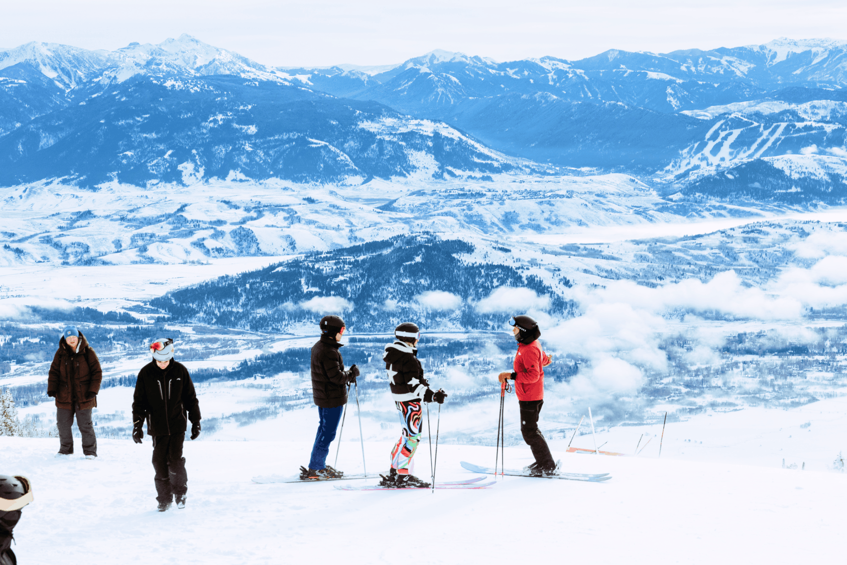 Geodesic dome in front of stream and Teton Mountains with pins pointing out JHMR, Grand Teton National Park, and Yellow Stone National Park.