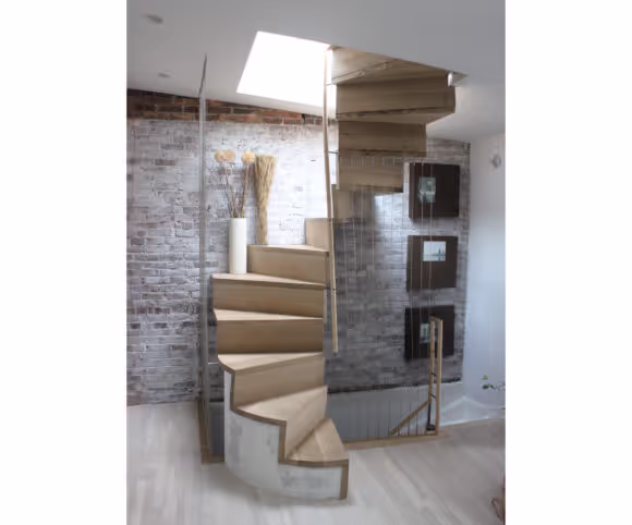 light shines through a trap door onto a wooden spiral staircase
