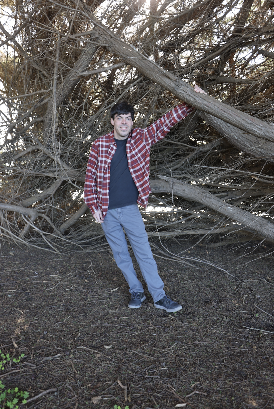 Blake next to a tree.