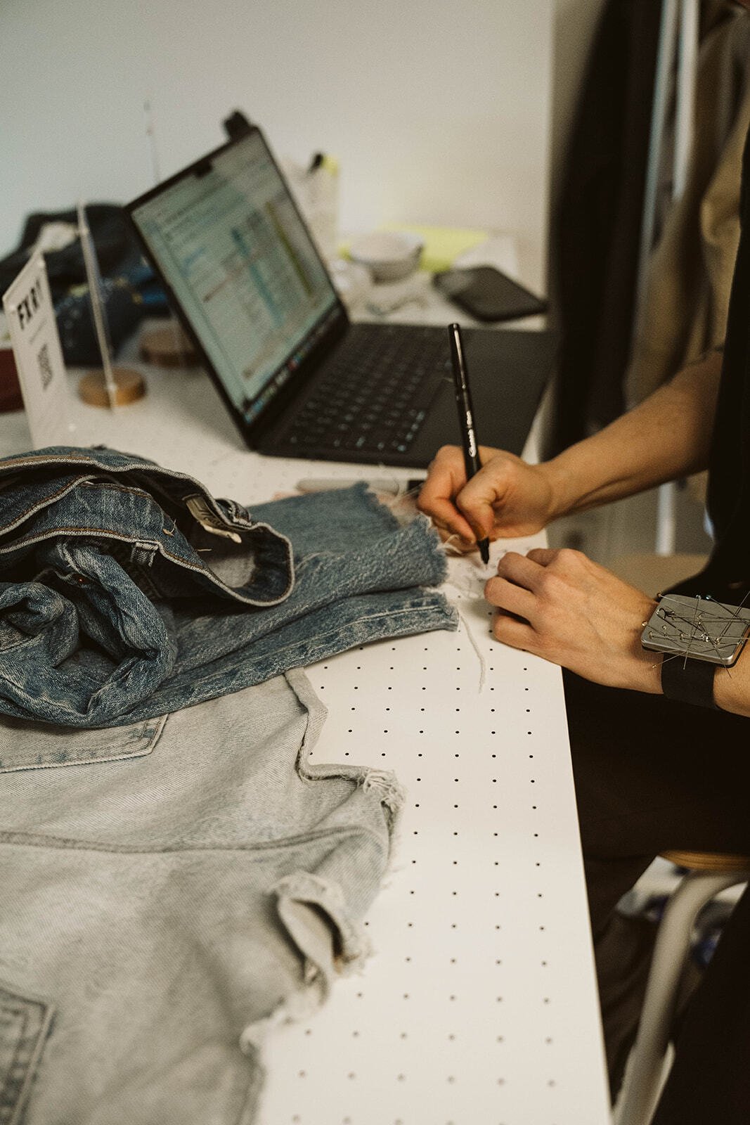 FXRY studio desk with denim and a laptop for walk-in service