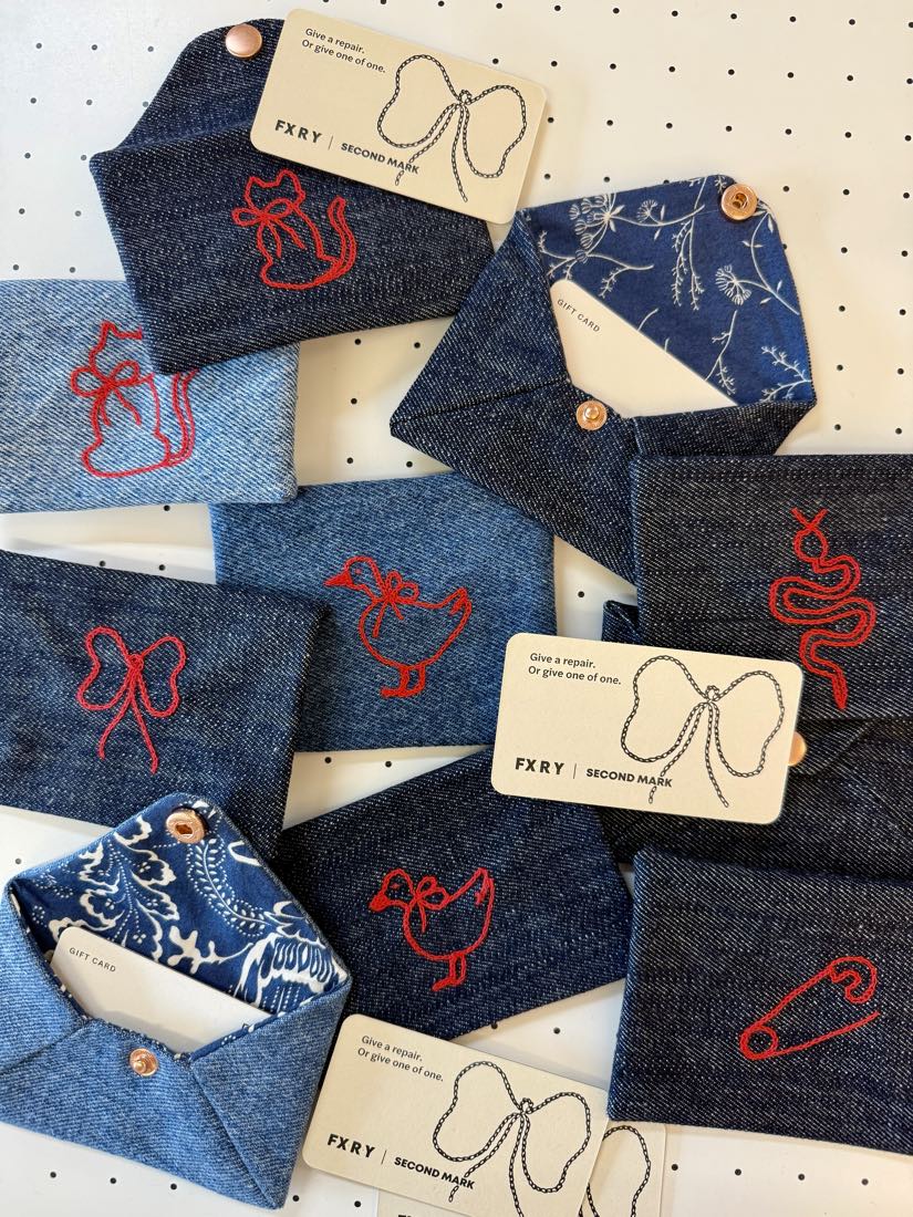 Denim gift card envelopes stitched by hand at FXRY in Seattle, each one different.