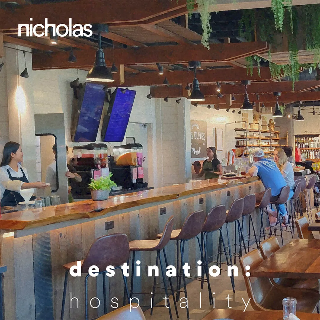 Hospitality interior featuring a modern bar with wood design and greenery, where people connect and improve quality of their life