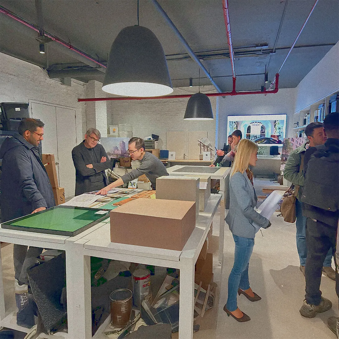 Architects reviewing project plans in a studio, embodying mentorship and collaborative design