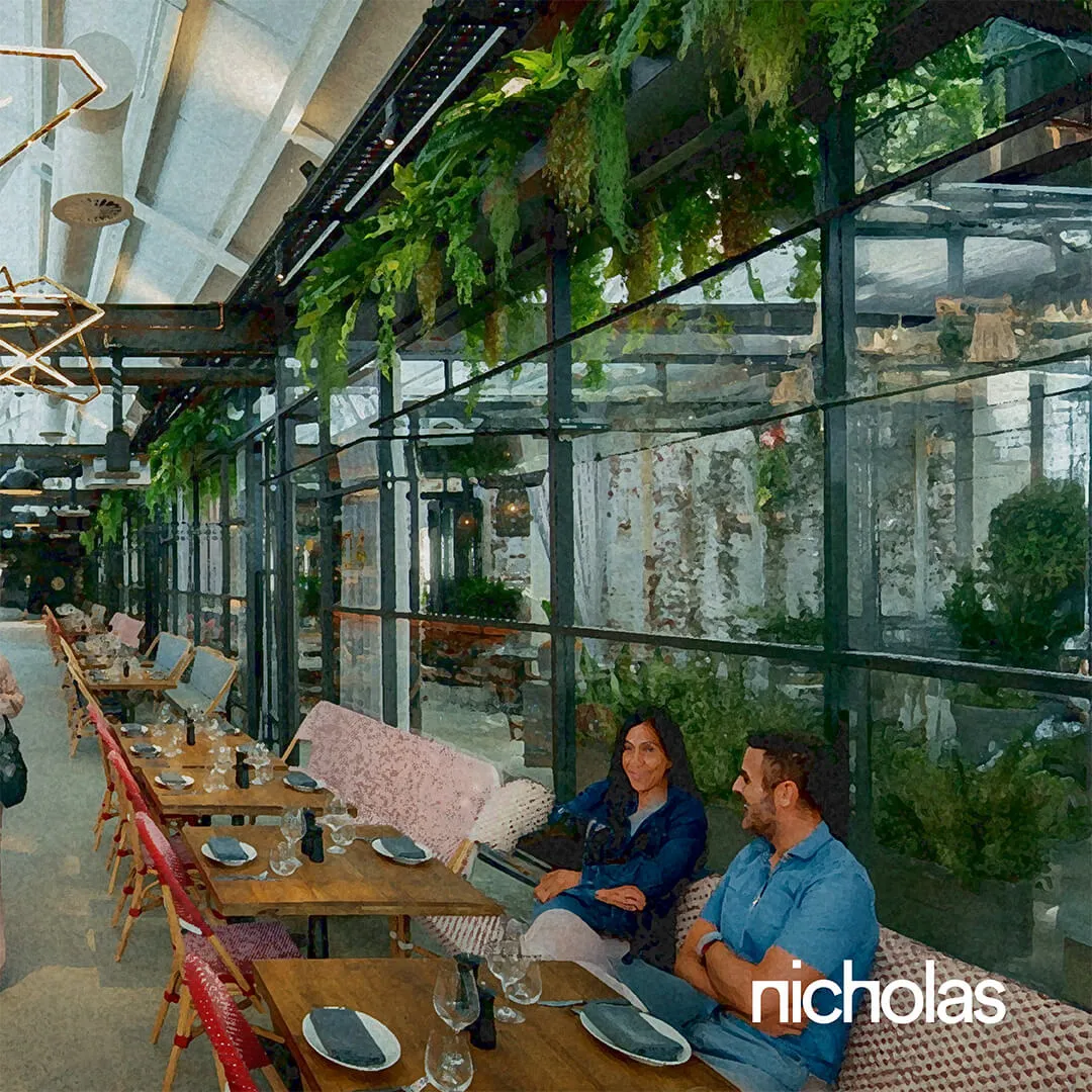 Restaurant with shared tables and social spaces acting as the heart of a mixed-use urban development