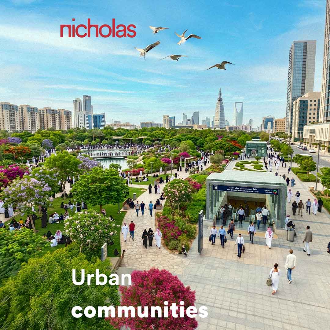 An aerial view of a dense urban center featuring a large green park filled with trees, birds in flight, and people walking, illustrating the role of urban parks as active ecological and social spaces within the city
