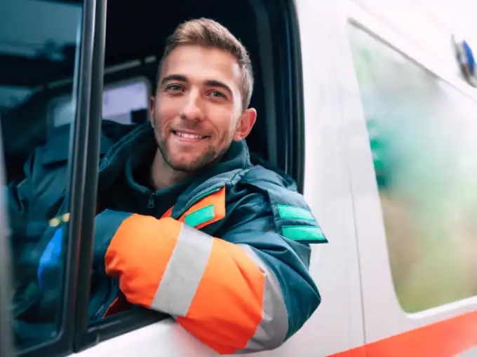 Handsome male paramedic with short brown hair driving ambulance and hoping to being a Physician Assistant bridge